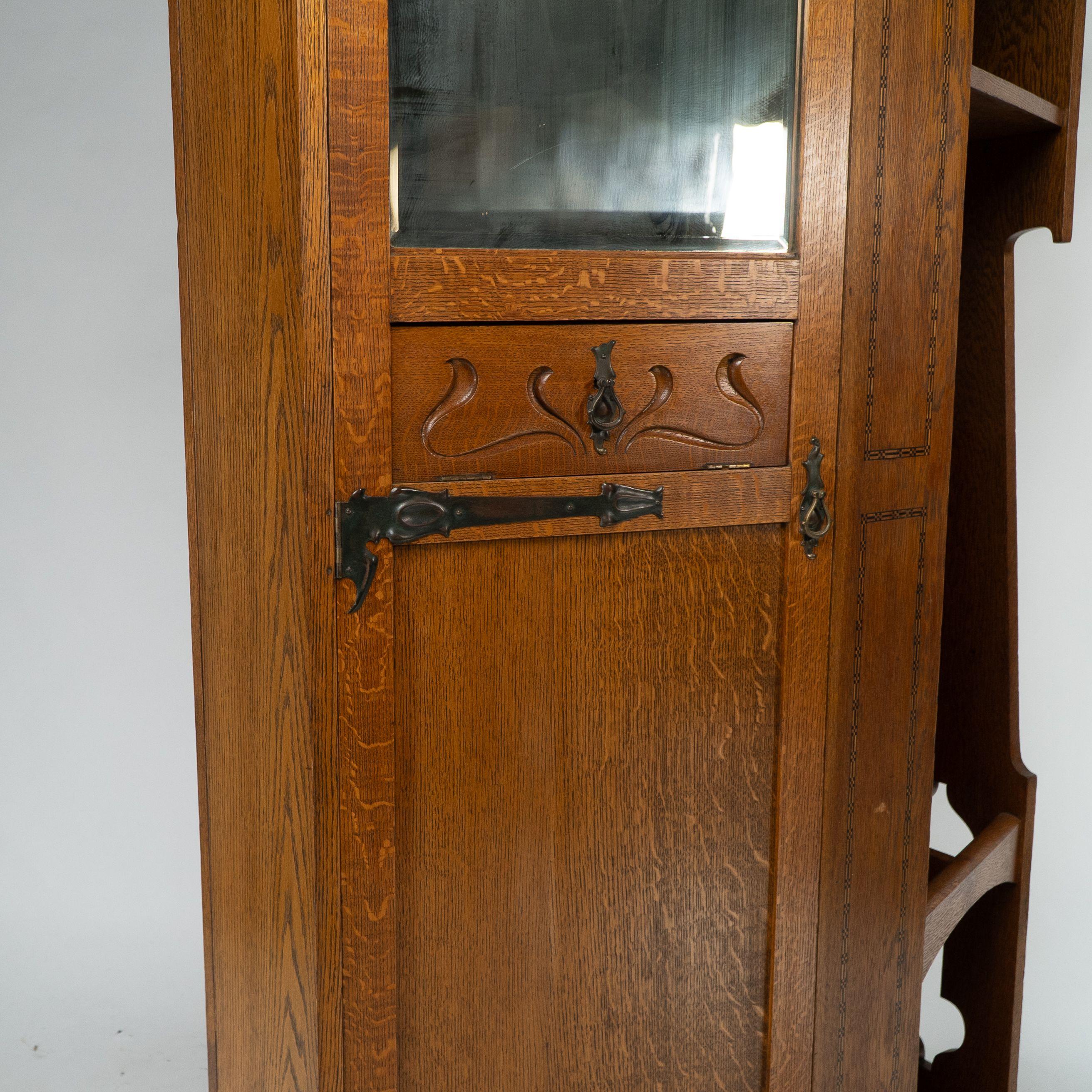 Shapland & Petter attri. An Arts & Crafts oak hall cupboard with flaring cornice For Sale 2