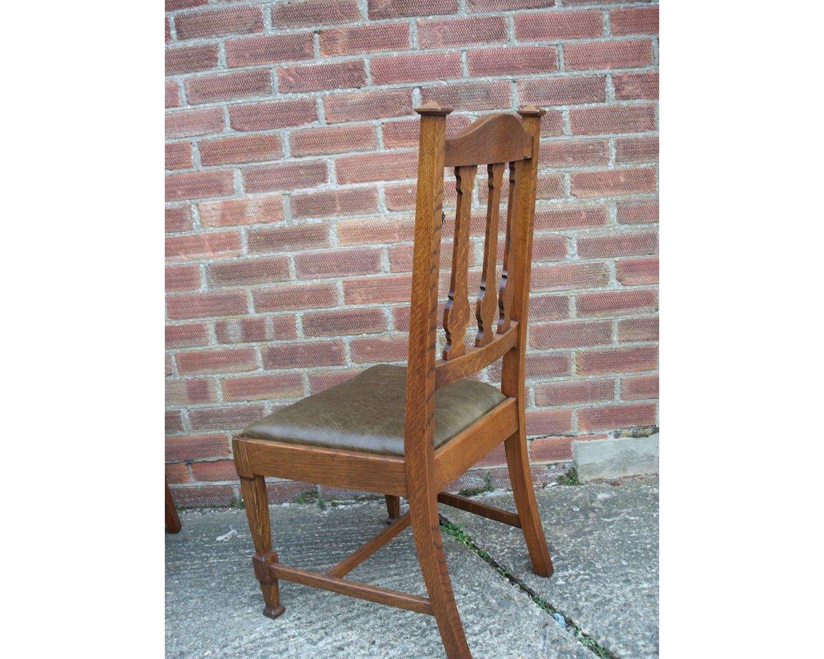 Hand-Crafted Shapland & Petter, Four Arts & Crafts Oak Dining Chairs with Floral Details For Sale