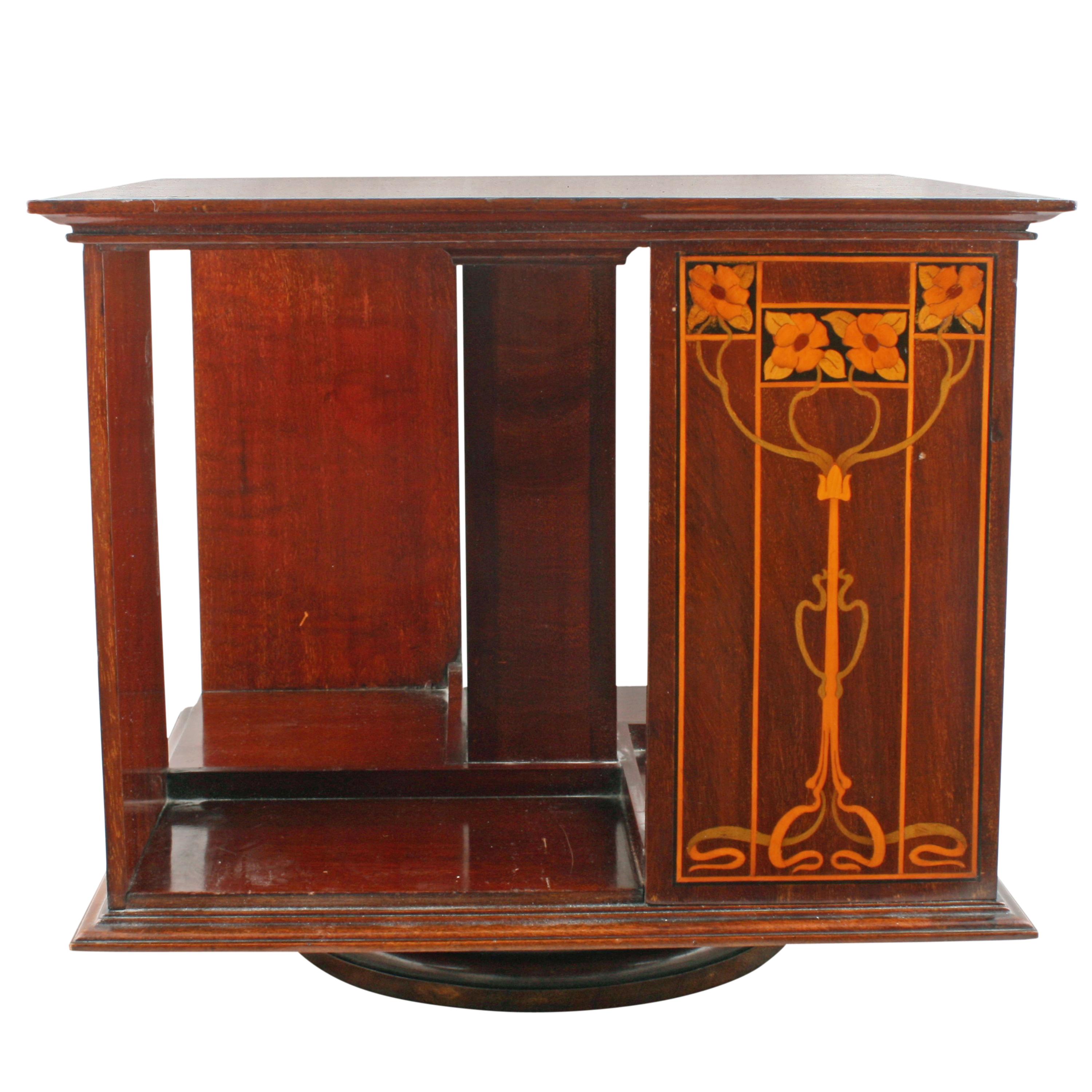 A late 19th century desk or tabletop mahogany revolving bookstand by Shapland & Petter.

The bookcase has four vertical panels of Art Nouveau inlay and four small inlaid squares top surface.

The bookcase sits on a circular plinth base with a