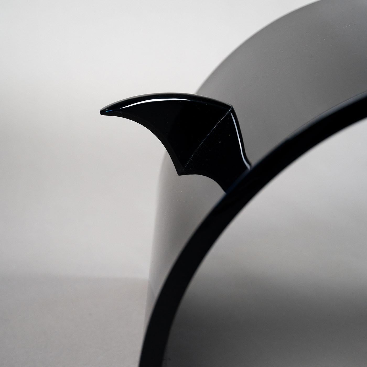 Clean lines arranged in a sculptural ensemble lend this handmade black PMMA chair its unmistakable contemporary feel. Distinguished by a pair of shark fin-like elements protruding from the back to convey a sense of audacity and bravery, the chair's