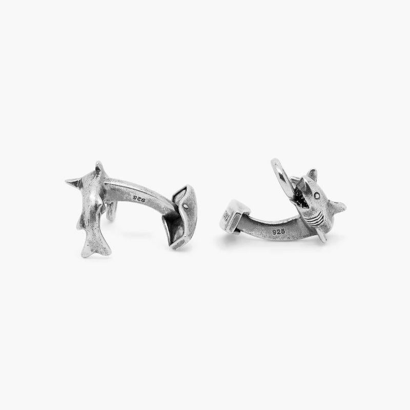 Shark Cufflinks in Antique Finished Sterling Silver

Six refined senses make sharks one of the most highly skilled hunters in the seas, and our fun adaptation portrays the feared animal in action, gripping a lifebuoy with its teeth. The ring has