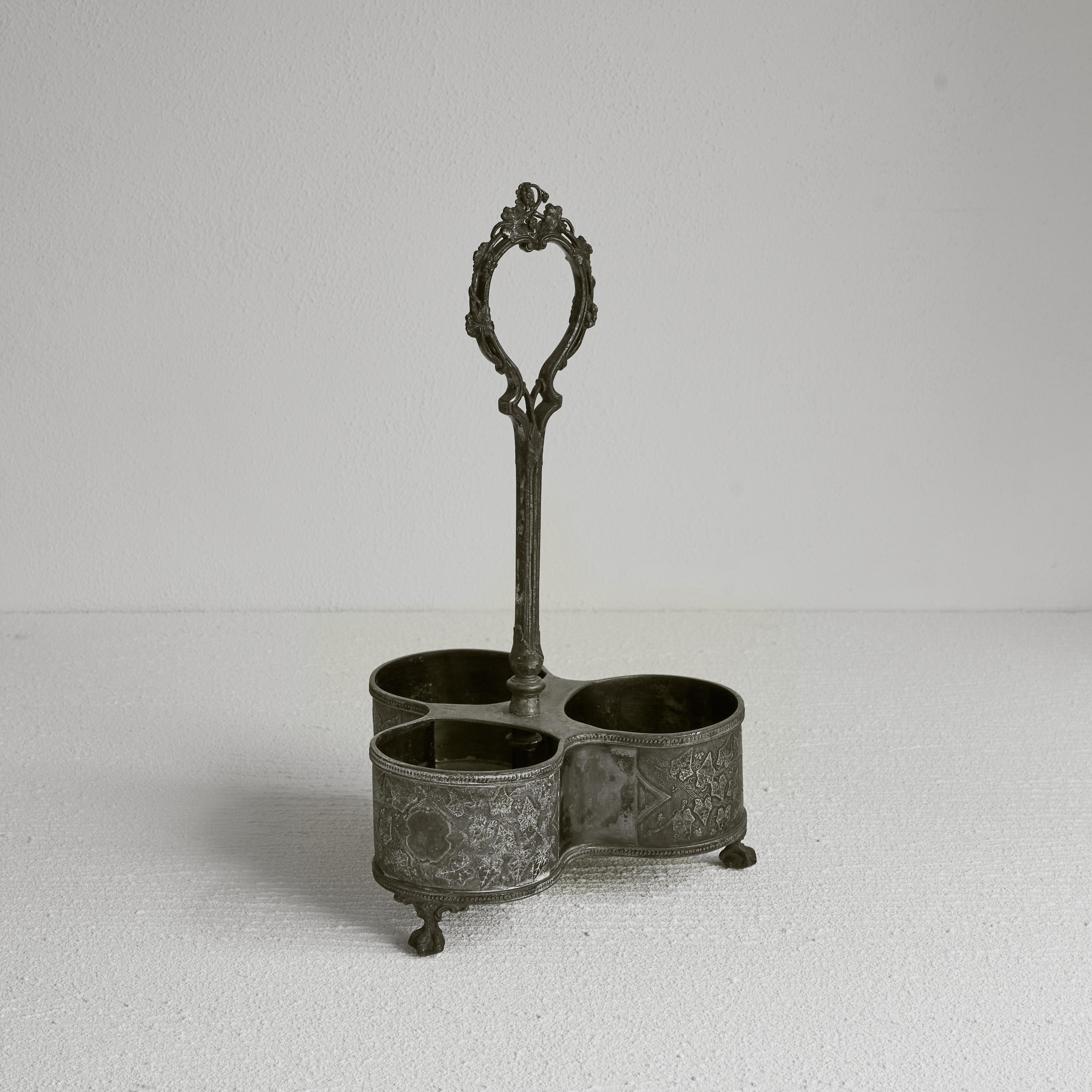 Shaw & Fisher Antique bottle holder in Patinated Silver. England, 19th century. 

Wonderful bottle holder in patinated silver made by Shaw & Fisher from Sheffield. Great Victorian design and a great appearance due to the general shape and