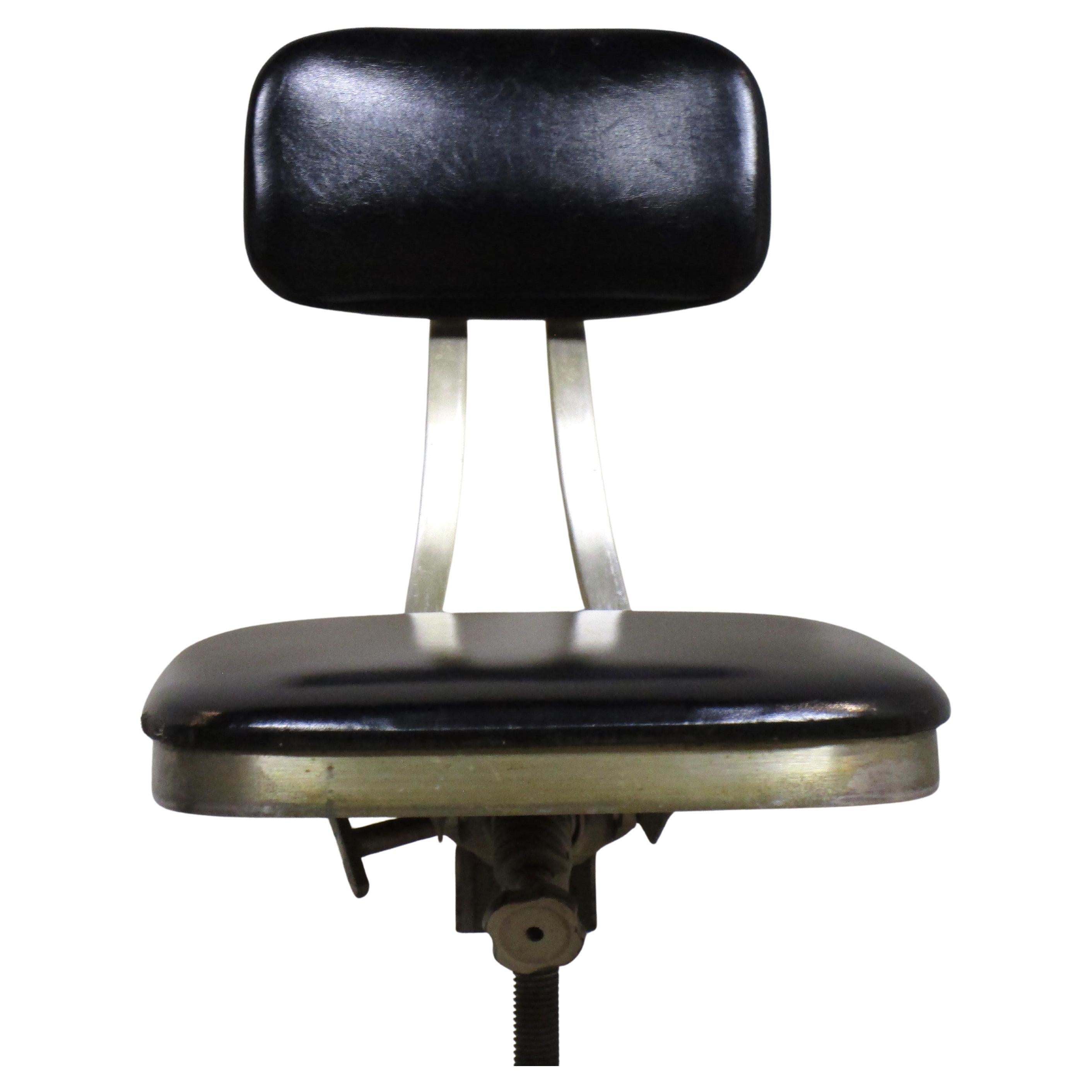 Shaw Walker American machine age industrial swivel task chair w/ aluminum propeller base / black vinyl upholstery at seat and back rest / adjustable mechanisms at back and under seat / orginal swivel casters w/ solid rubber wheels. Shaw-Walker