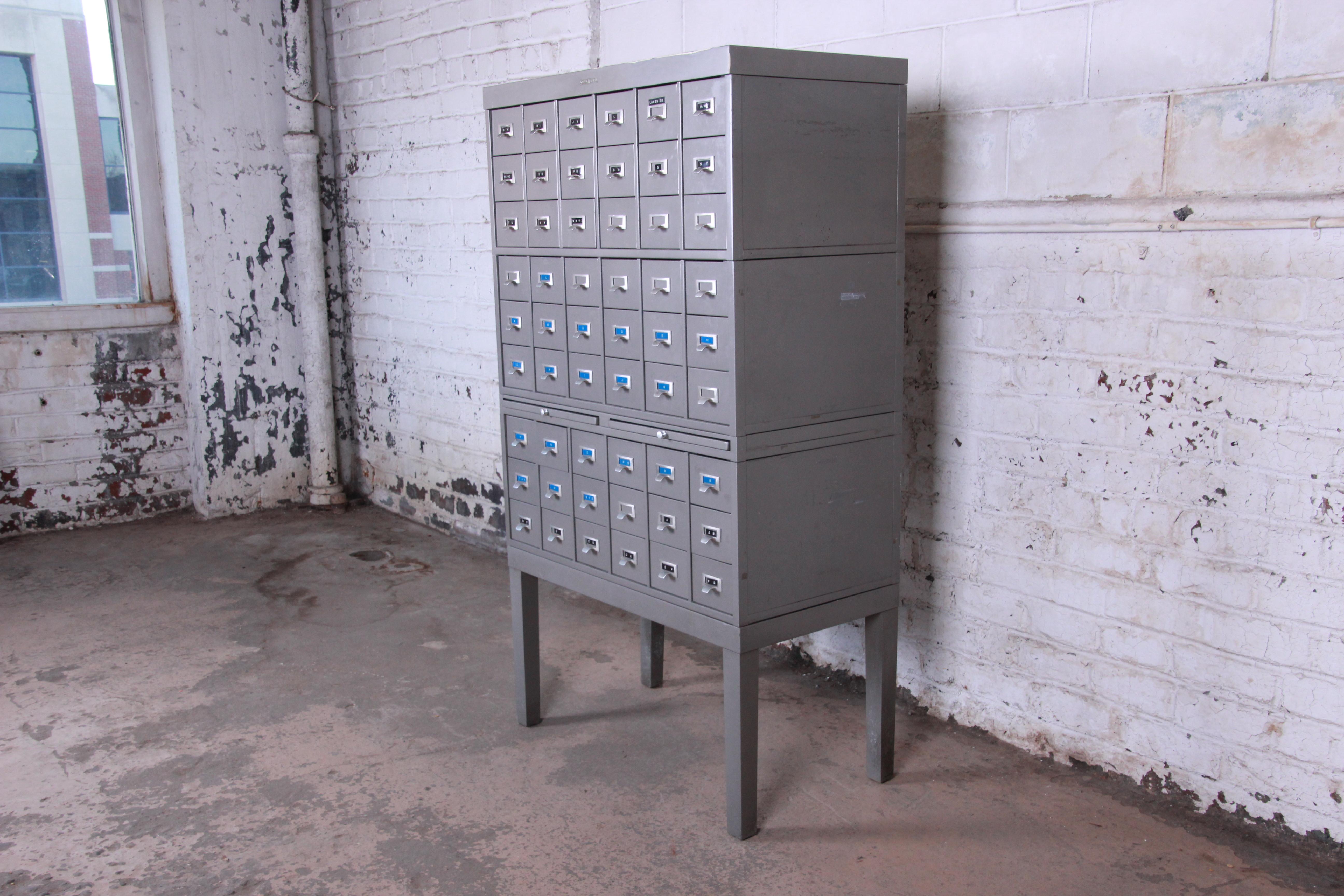A rare and unique Mid-Century Modern industrial age metal library card catalog by Shaw Walker. The catalog provides excellent storage with 54 drawers. Great for tools or parts, Arts & Crafts supplies, and wine storage, among many other uses. It also