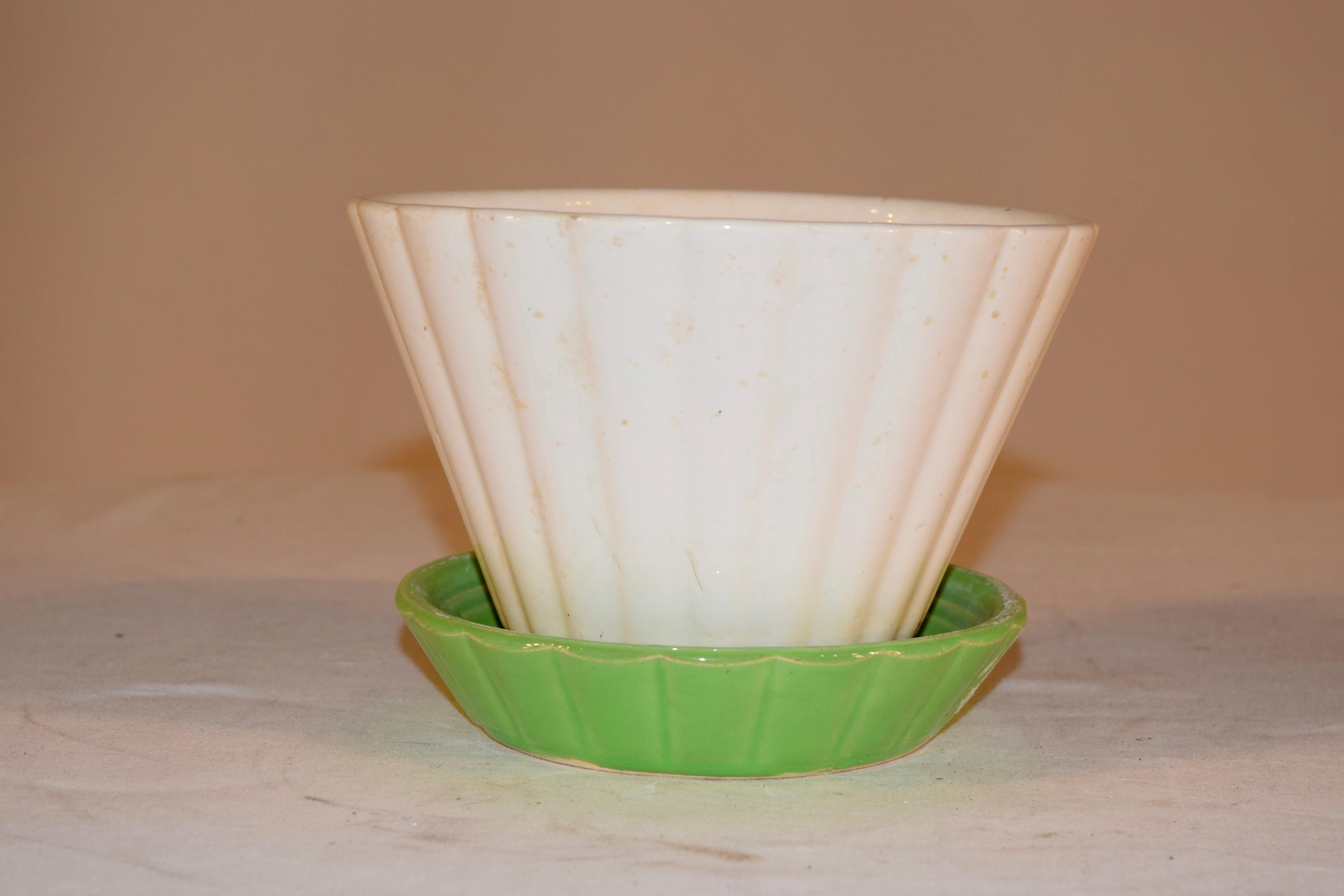 Vintage Shawnee pottery with attached saucer. Ribbed white planter has attached green saucer - known as 