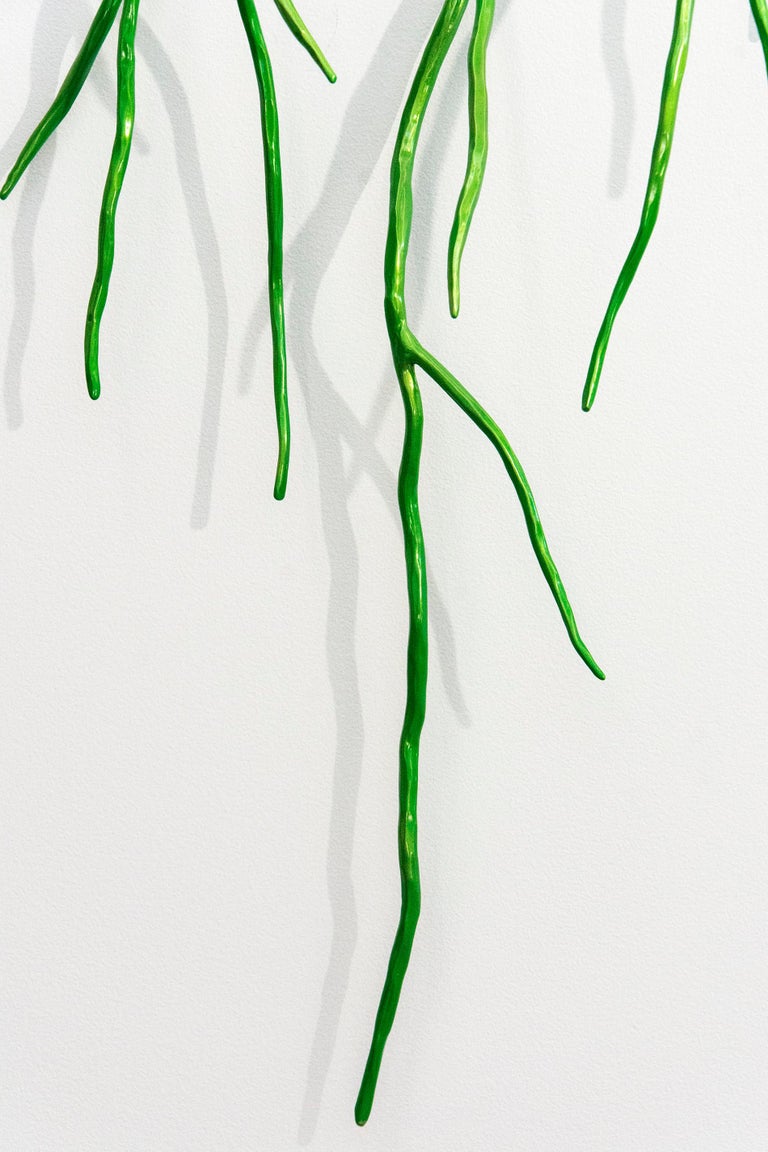 This striking, metallic candy apple green steel bough by Shayne Dark resembles a network of dangling branches. Poised between representation and abstraction, this intricate hand forged wall sculpture is saturated in eye-popping pigment. 

Evocative