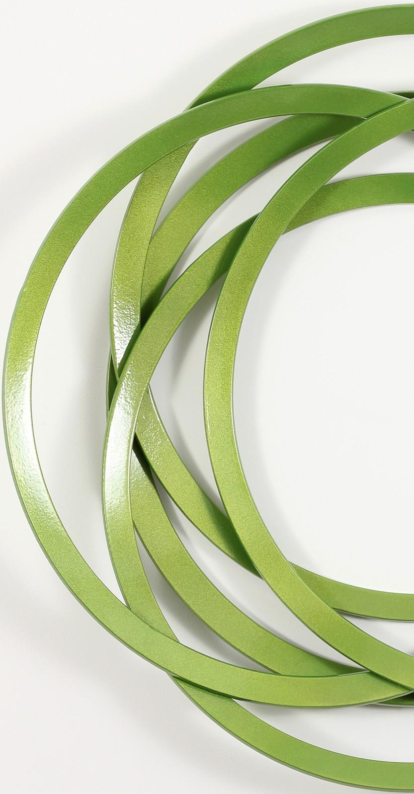 Slender rings of flattened steel powder coated in an eye-popping apple green are stacked to create an elegant yet playful geometric wreath. Known for his intricate and contemplative wall mounted works, master Canadian sculptor Shayne Dark intersects