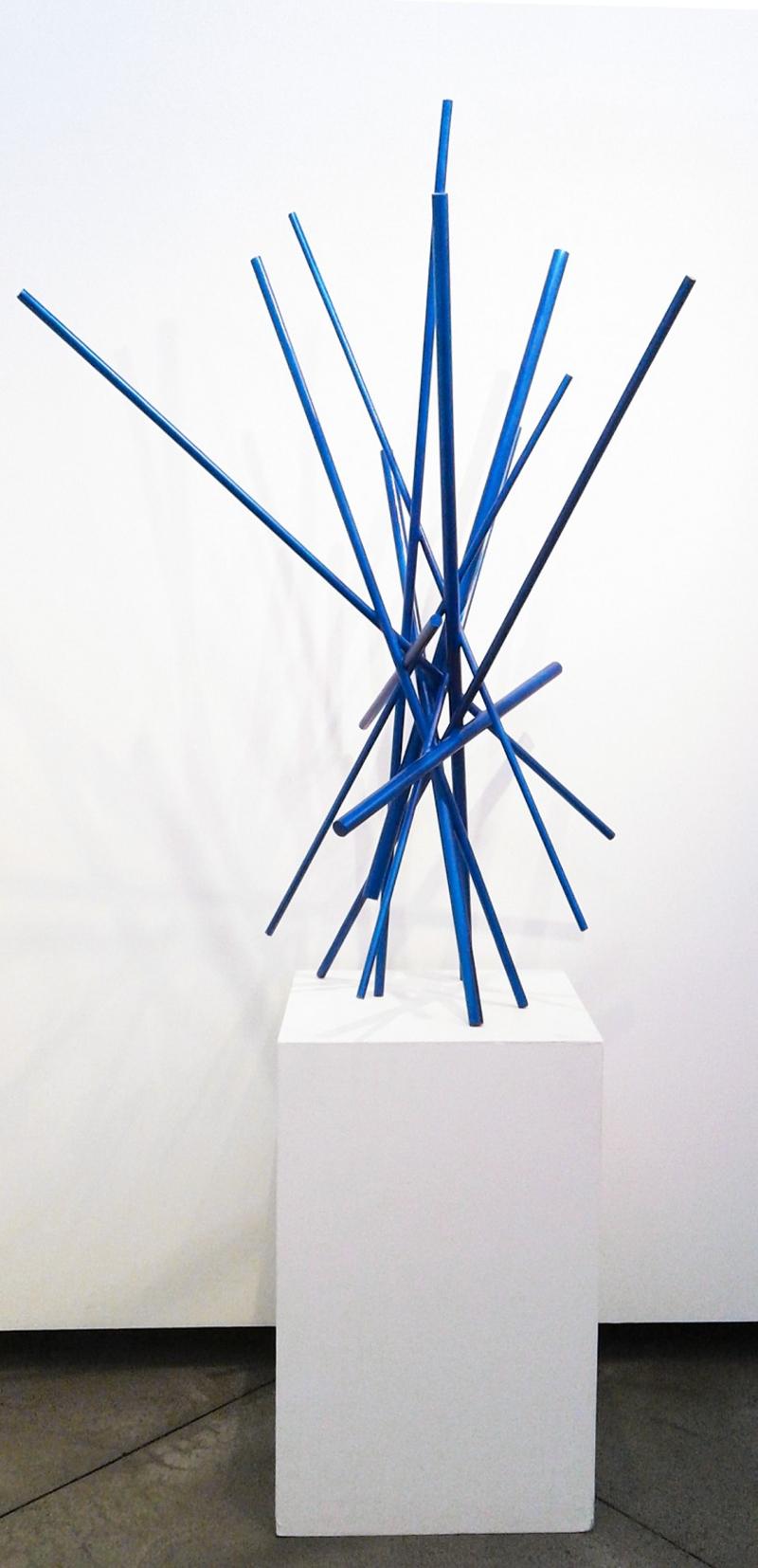 Saturated in cerulean—like the colour of a deep blue sky, intersecting lengths of wood form a dramatic sculpture in this abstract piece by Canadian artist, Shayne Dark. From his studio in the countryside, Dark is constantly inspired by his natural