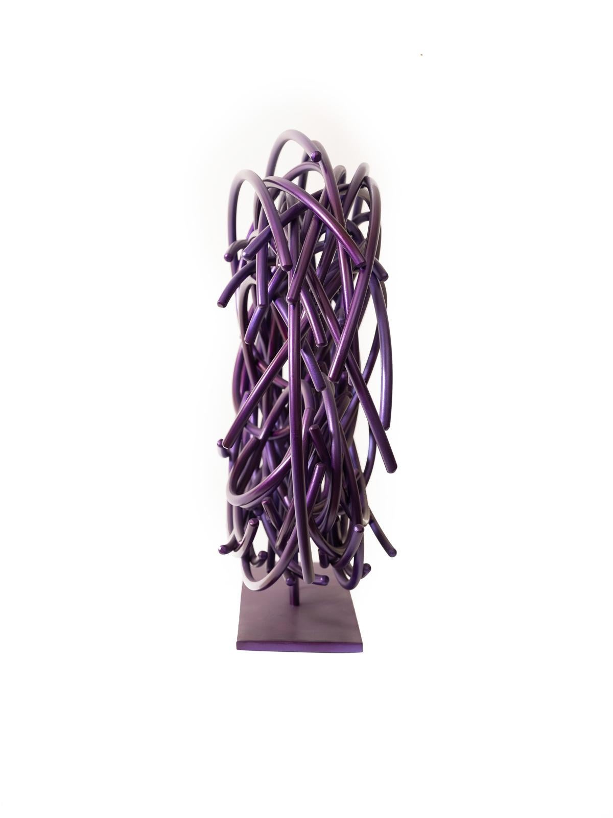 In a gorgeous aubergine colour, this dynamic sculpture by Shayne Dark is part of an exciting new series called Maelstrom. Known for his uniquely beautiful abstract work, this piece is hand forged from small round aluminum rods formed into a circular