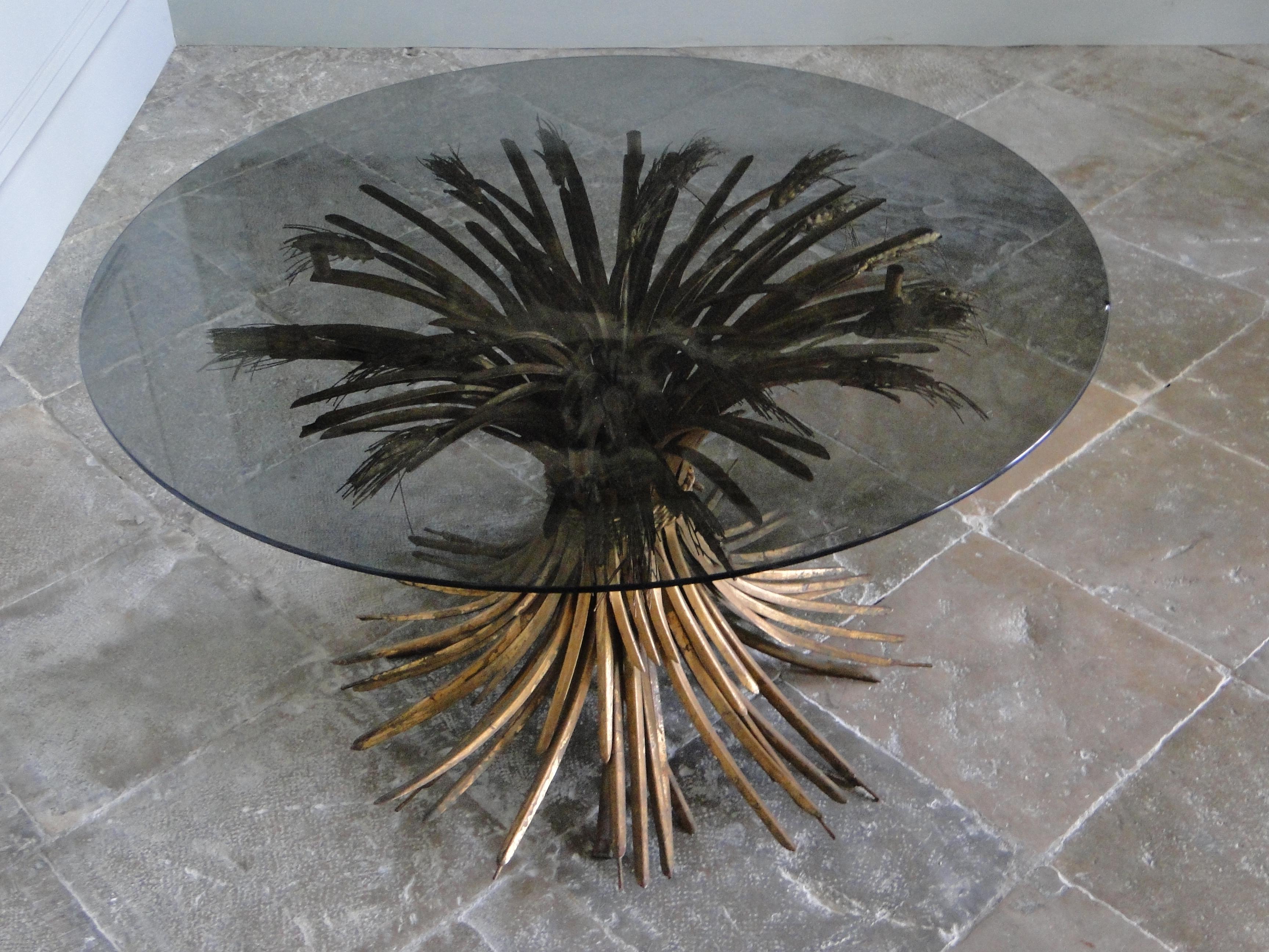 Sheaf of Wheat beard sofa table similar to the one sold on Chisties by Bergé. They have been made for Coco Chanel and Yves St Laurent in the 70th. Gilt Iron with a smoked glass top.