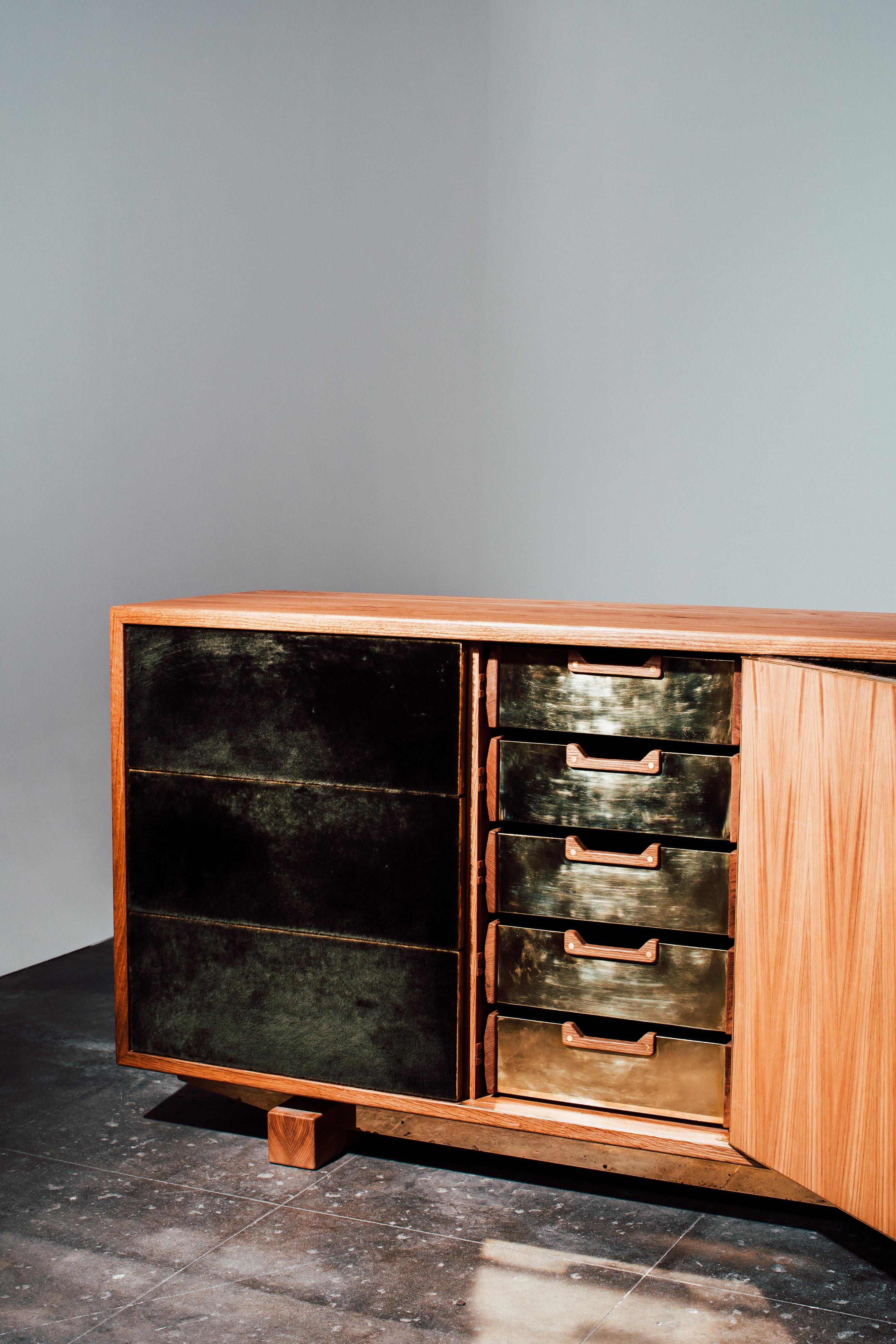 One of the first pieces of our Shear collection that uses a super soft hand dyed straight hair lamb shearling from Italy. Solid white oak casing and hand carved joinery and brass accents. Push to open drawers with a push to open center door that