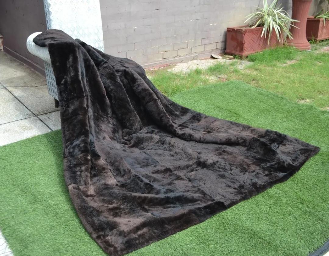 This is a beautiful and luxurious sheared beaver king size blanket.
Soft pelts and rich dark brown color accented with black backing.
This is perfect for a bed or just for sitting under on the couch. The perfect touch of luxury and would make an