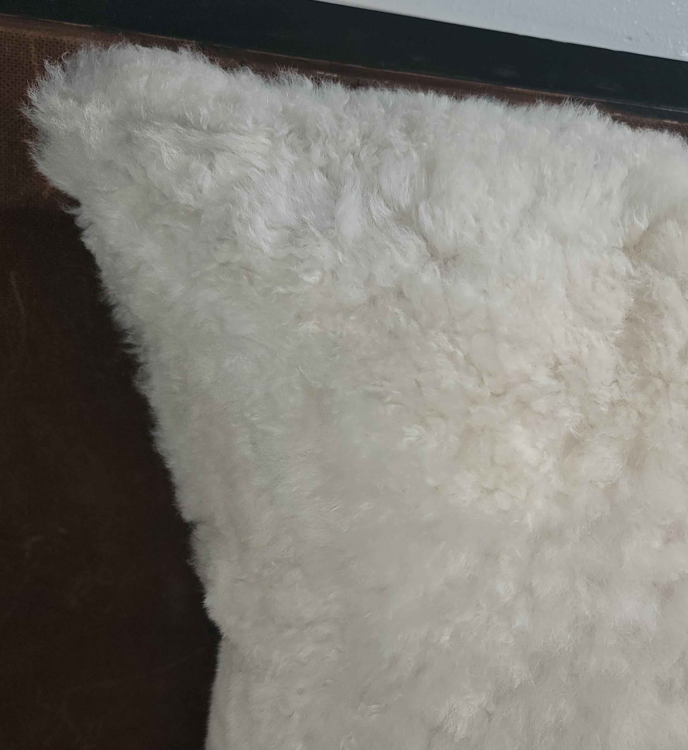 Amazing hand crafted sheepskin pillow with suede backing and down & feather fill.Amazing only one in stock.