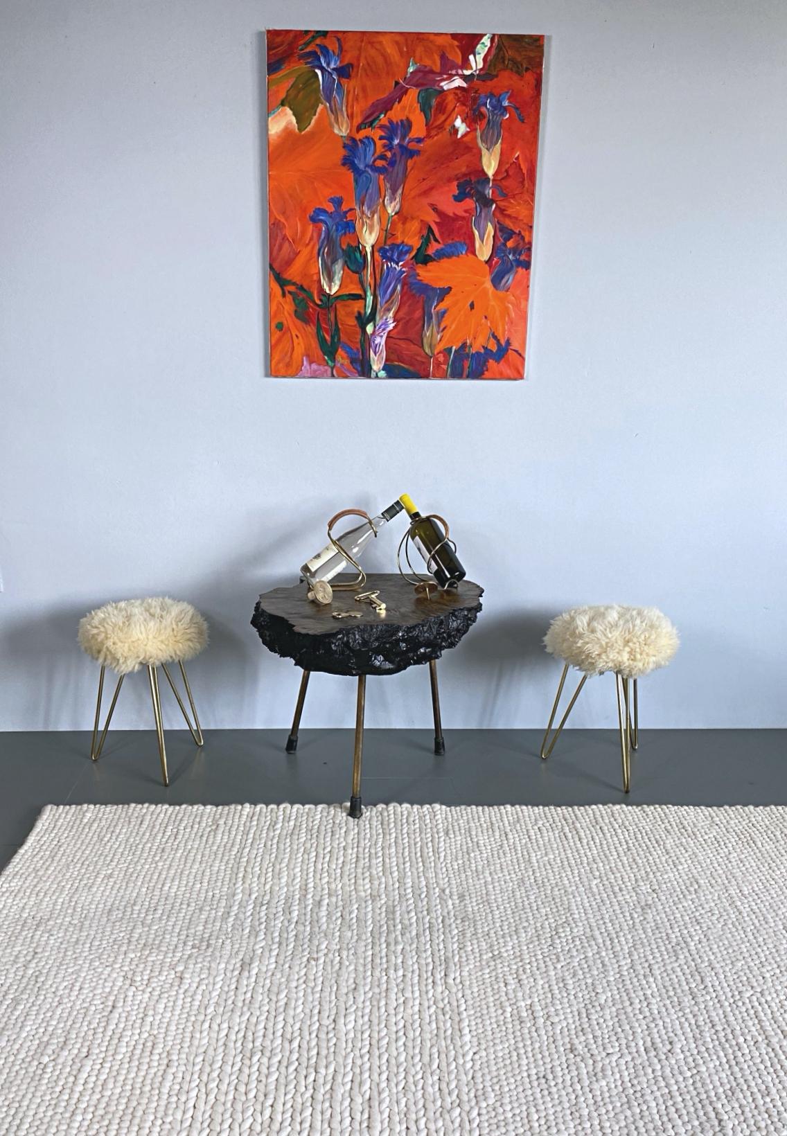 Pair of very decorative French 1950s shearling stools. The three brass hairpin legs serve as a reduced, minimalist counterpart to the wild fur. Freshly professionally cleaned.

We found these objects at an antique fair in Southern France.

We