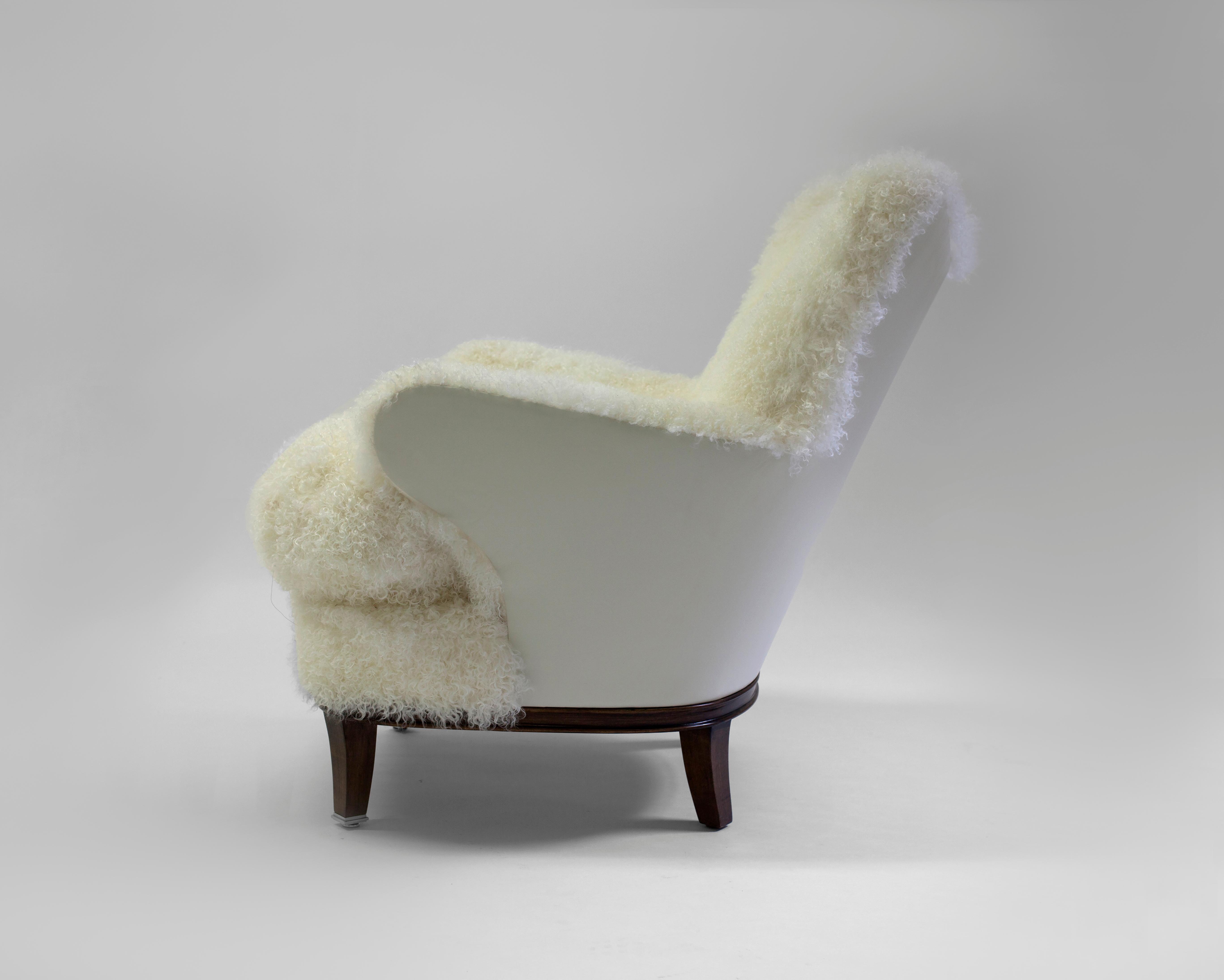 The Willow club chair is a whimsical chair that can be used in any room - shown covered in shearling with button detail on inside back with a contrast leather on the outside back and arms - soft foam with feather and down fill in loose seat cushion