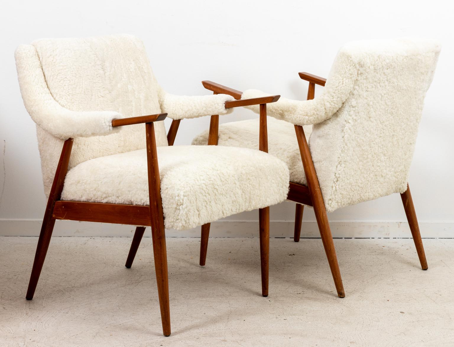 Circa 1960s Shearling Danish Modern style armchairs, freshly upholstered in lamb shearling. Made in Denmark. Please note of wear consistent with age including scratches and minor finish loss to the wood frame.