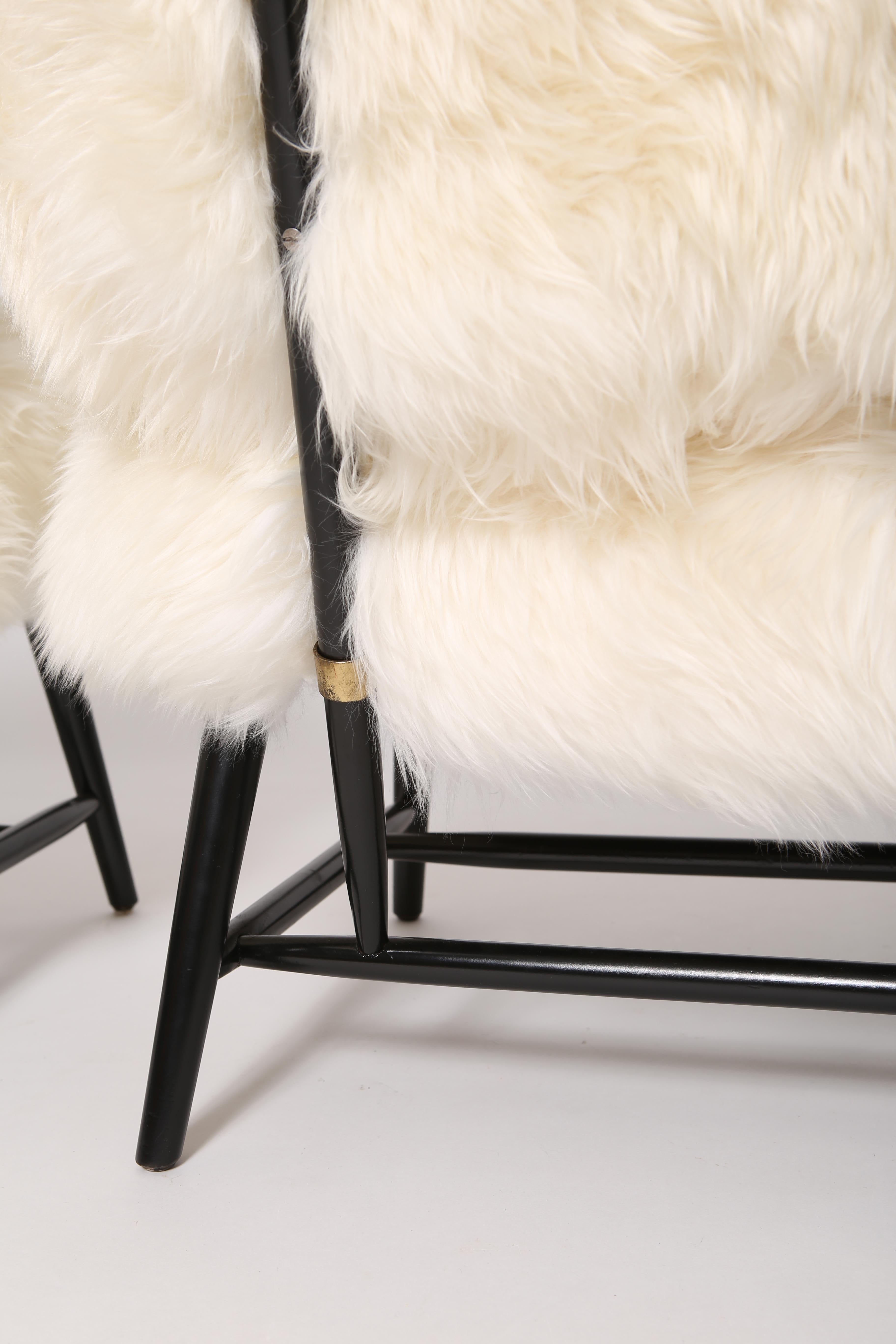 “TeVe” chairs, by Alf Svensson for Dux. Sold as a pair. Lacquered beech frames, brass hardware and redone in fluffy New Zealand shearling. These are wonderfully fluffy yet stout little slipper chairs- armless design is perfect for playing guitar