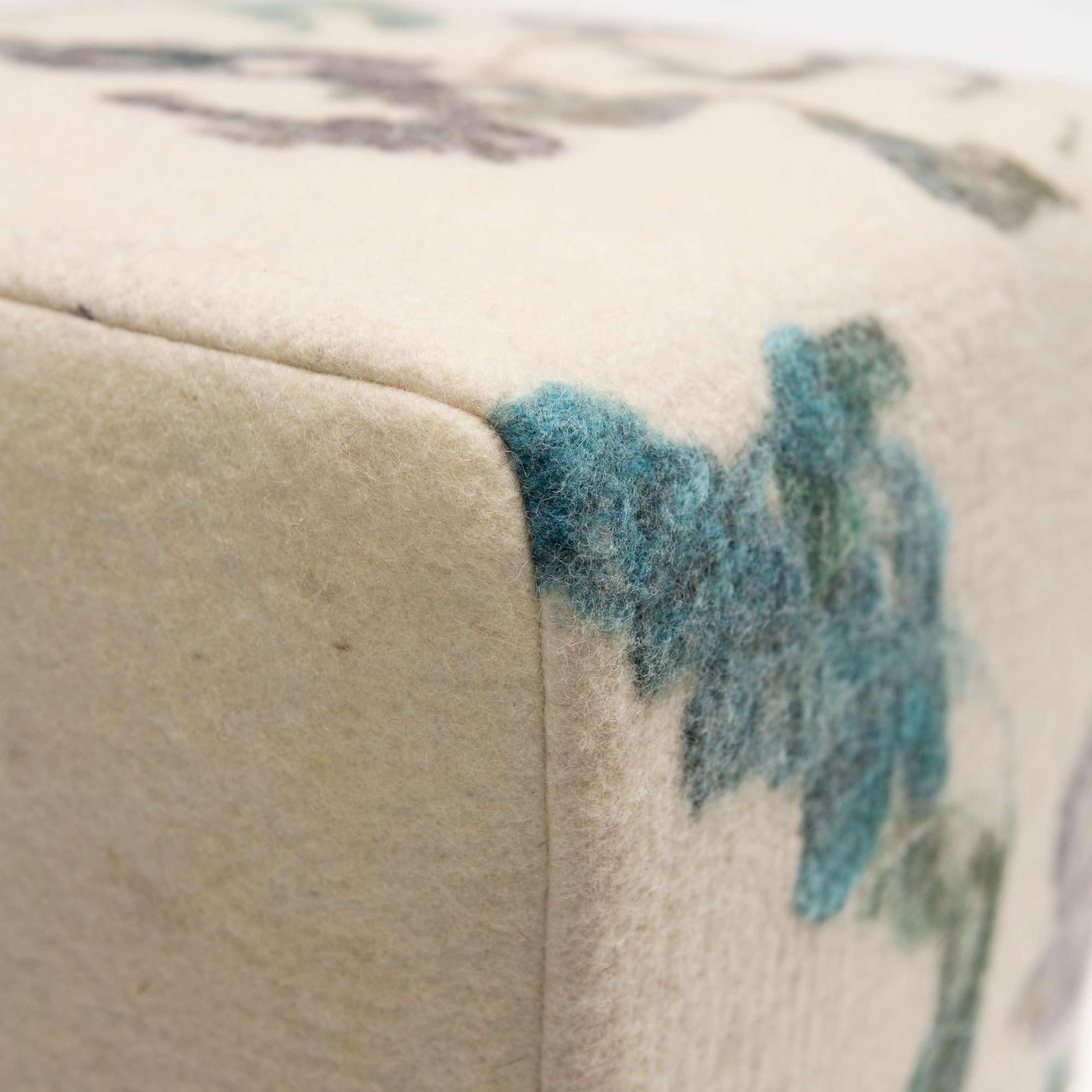 Felted wool fabric made in our workshop, each one one-of-a-kind from our painterly felted wool over a finely upholstered ottoman with wood legs.

The ottoman is manufactured in Portland, Oregon USA by an accomplished fine furniture builder for