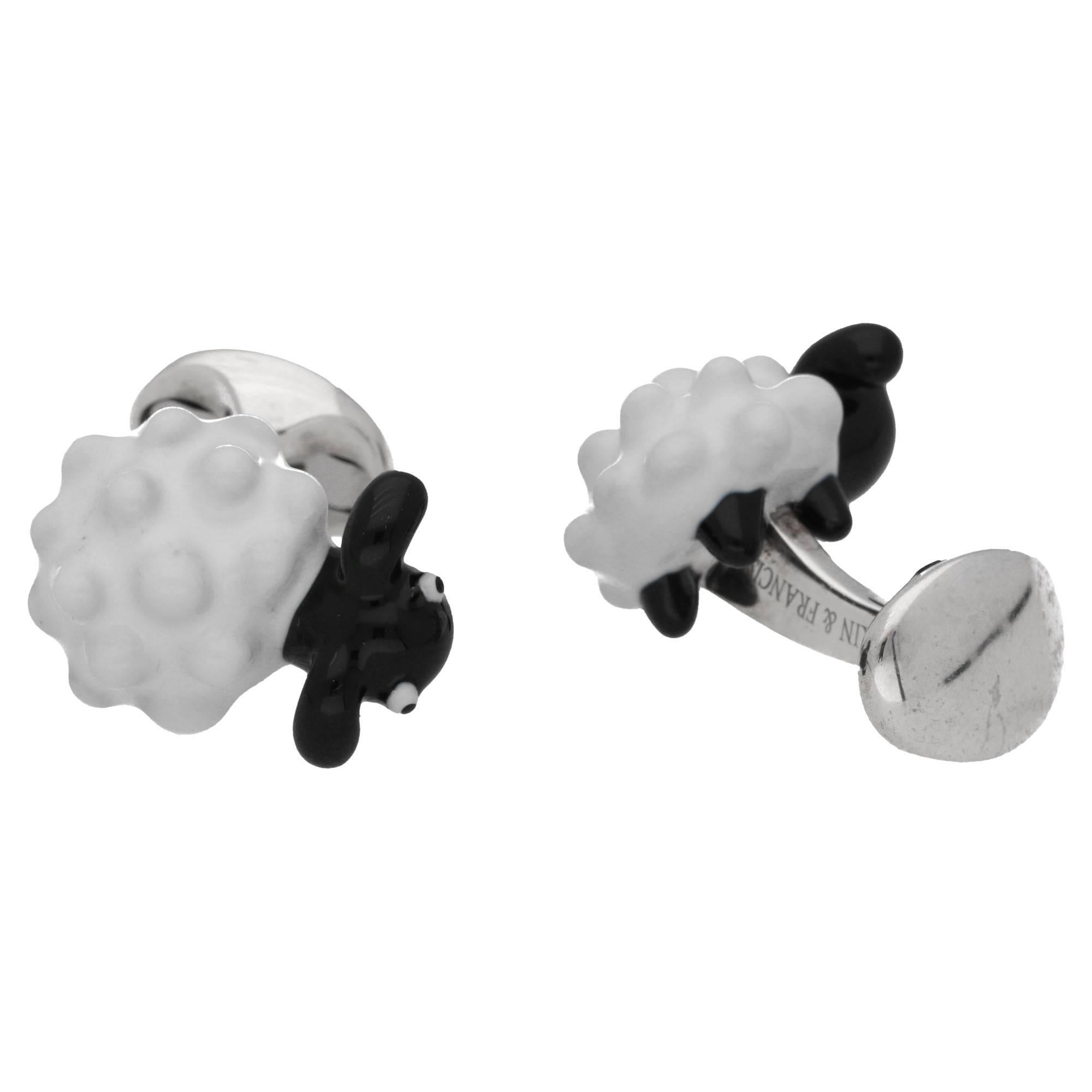 A pair of British .925 Sterling Silver and hand painted enamel sheep cufflinks, set on a small domed oval spring link fitting.
The fundamental techniques of enamel are cloisonné, champlevé and painted enamel. Enameling is glass fused to metal at