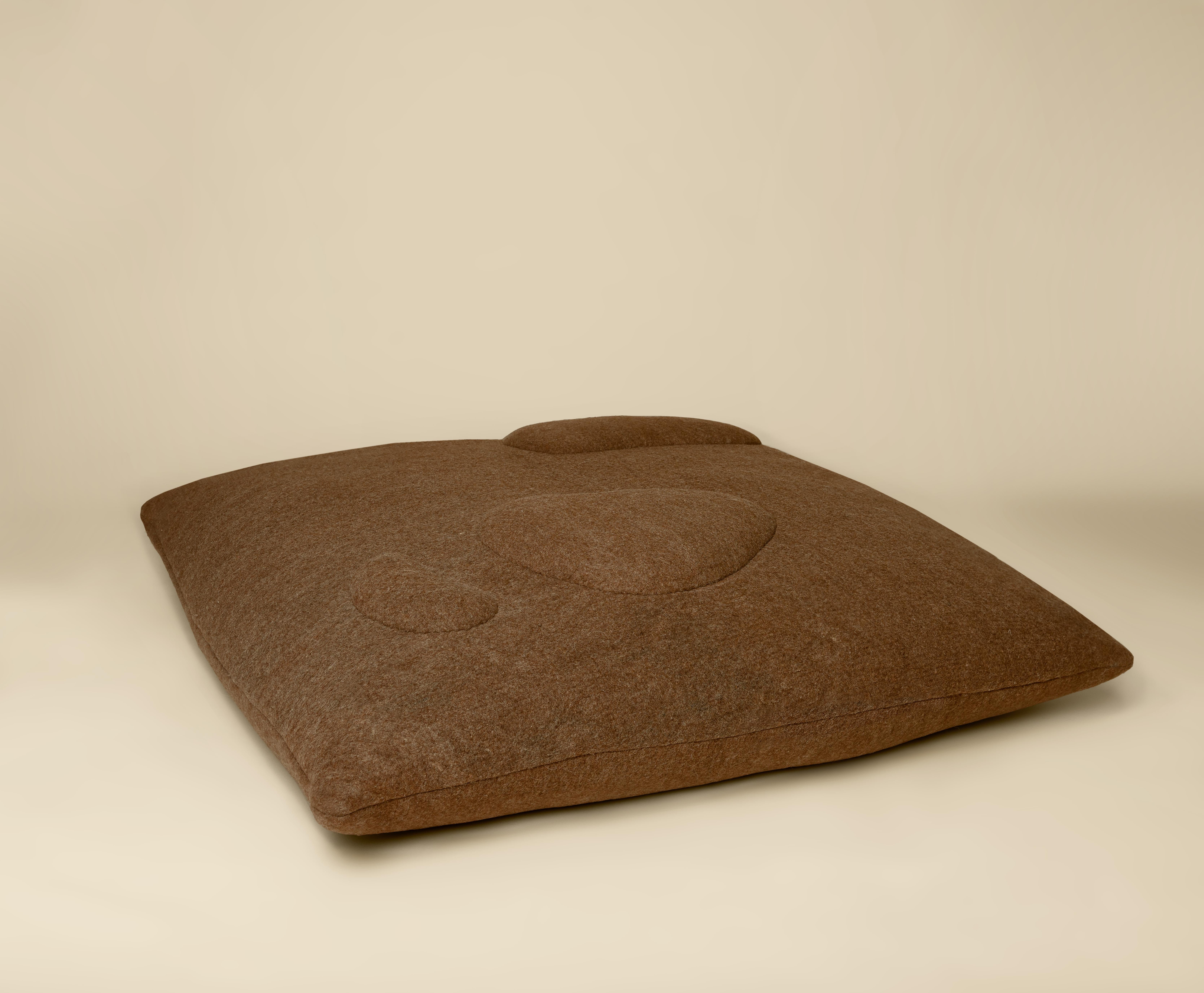 Sheep Floor Pillow designed by Studio Ahead in a collaboration with JG SWITZER. 

Textured like stones smoothed by water the felted wool fabric is a mix of local fleeces and silk/wool blends. Fabric designed in collaboration JG SWITZER using a