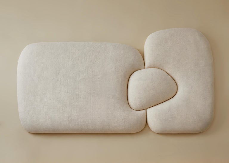Sheep Headboard designed by Studio AHEAD. This puffy and soft sculptural object could be used as a headboard or independent piece of art. 

It is upholstered in custom cream merino wool felt from Northern California sheep. The shape of the headboard