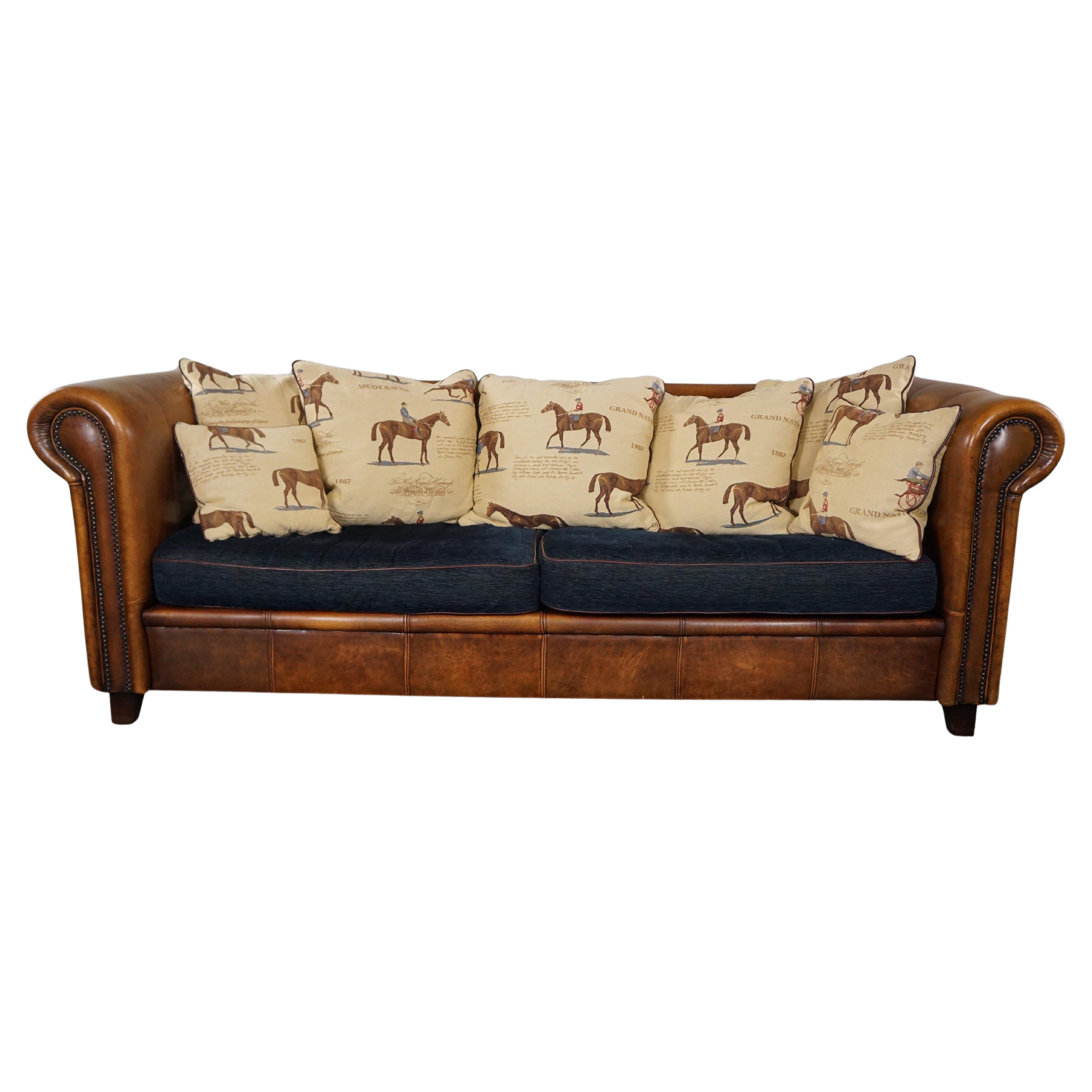 Sheep leather 3-seater sofa with fabric cushions featuring a horse motif For Sale