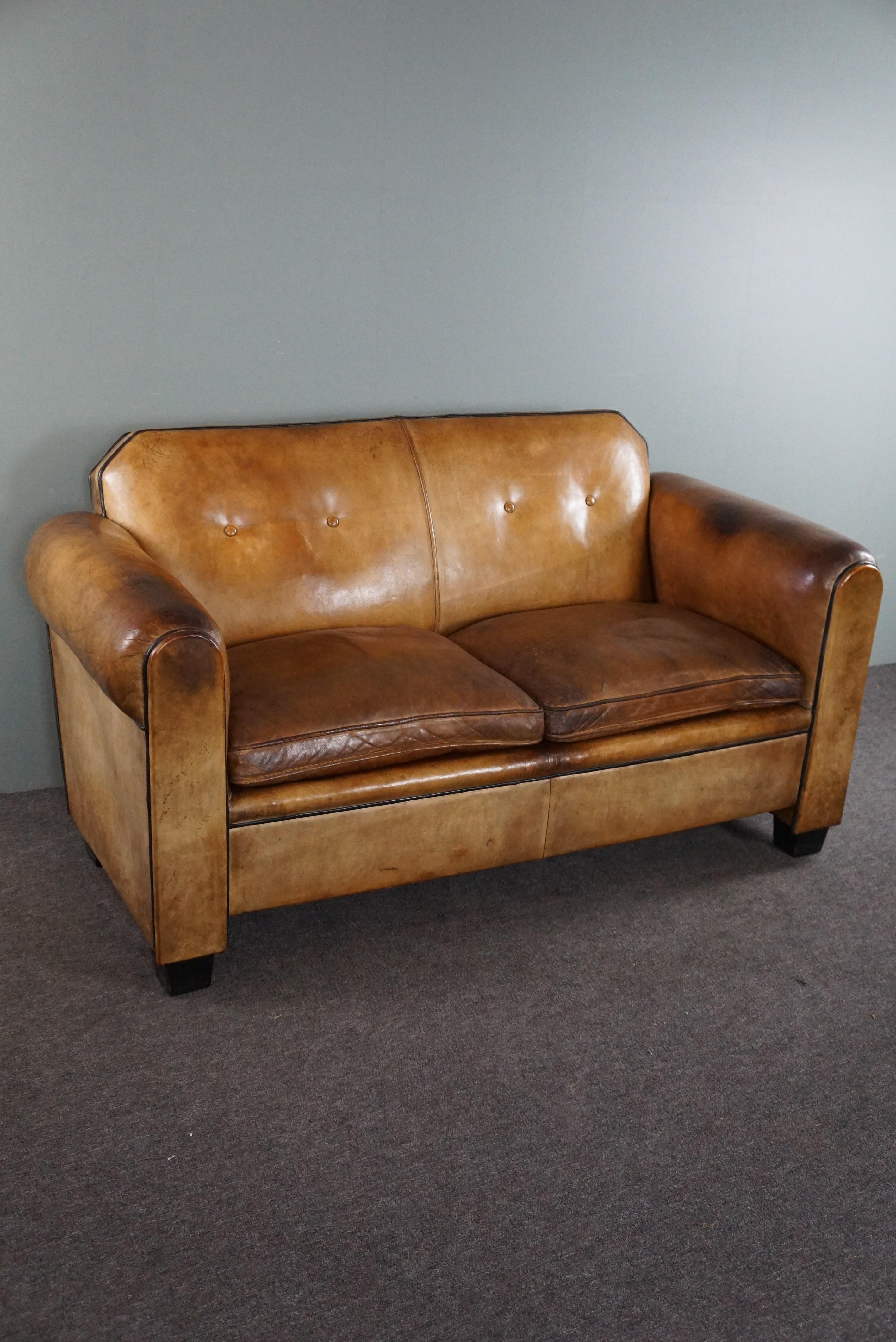 Offered is this sculptural sheep leather spacious 2-seater sofa designed by Bart van Bekhoven.

This striking pearl is not only spacious and comfortable, but also stately and grand in its appearance and design due to the color, patina and beautiful