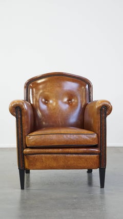 Sheep leather design armchair finished with decorative nails and black piping
