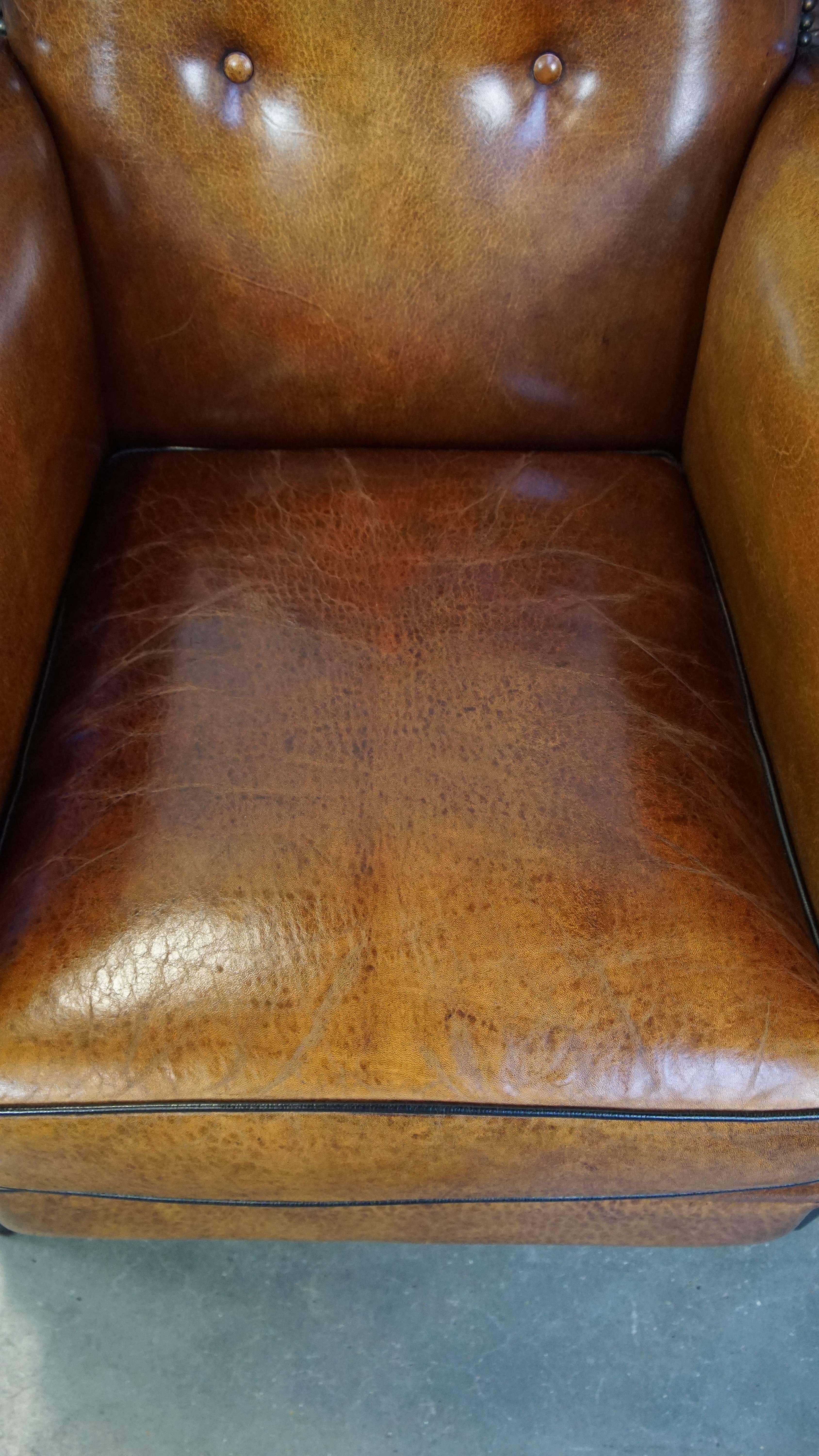 Sheepskin Sheep leather design armchair finished with decorative nails and black piping For Sale