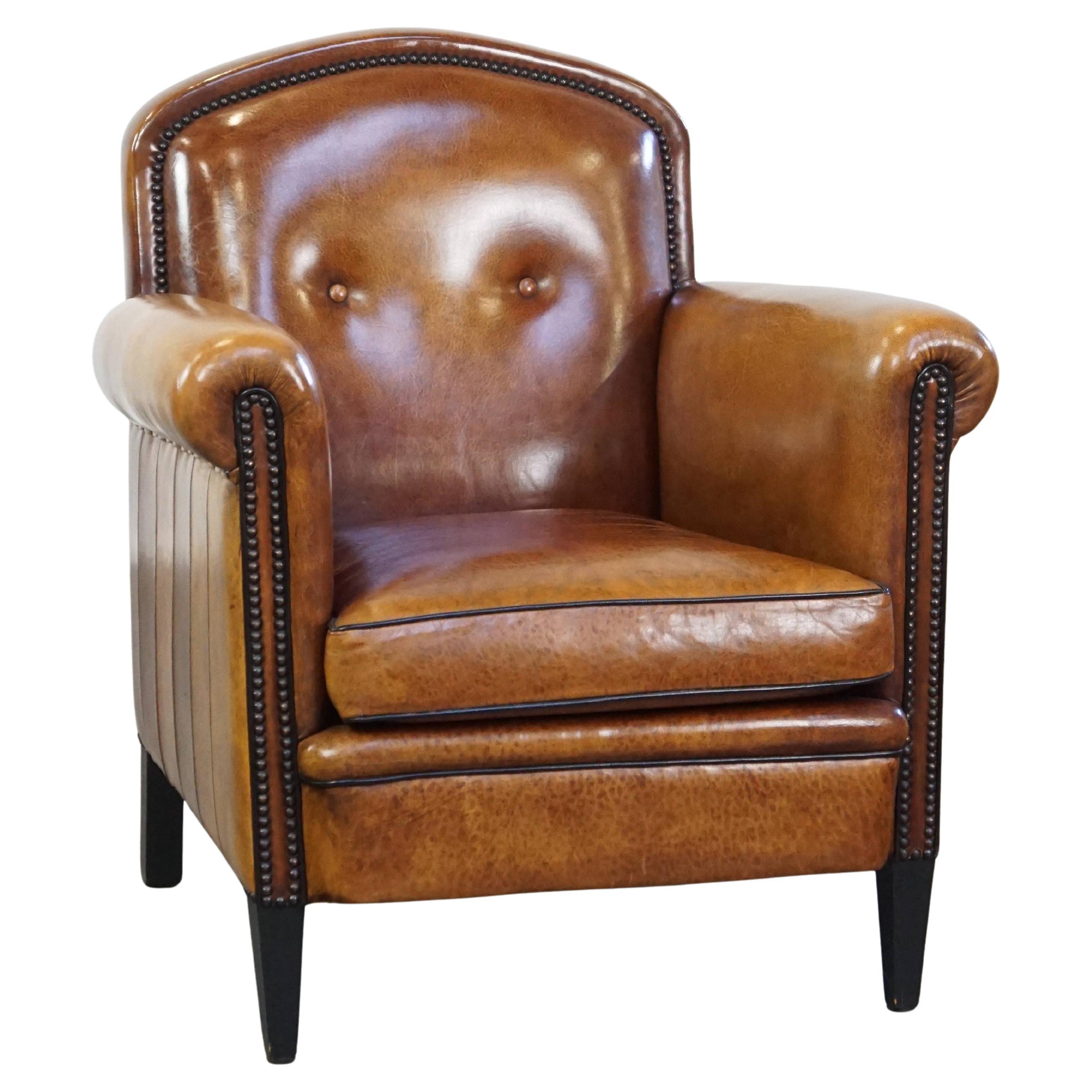 Sheep leather design armchair finished with decorative nails and black piping For Sale