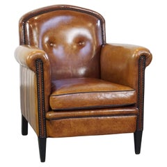 Sheep leather design armchair finished with decorative nails and black piping