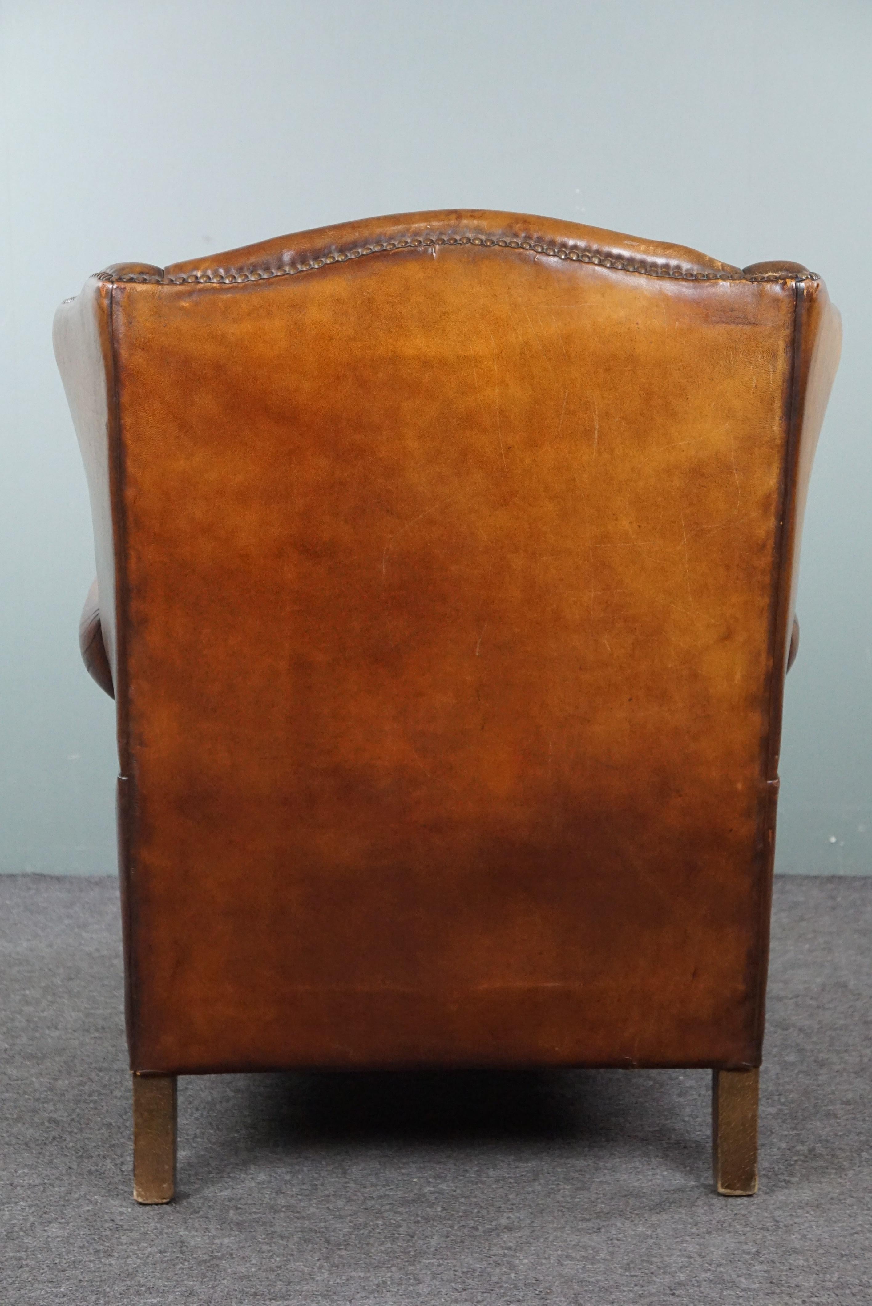 Late 20th Century Sheep leather wingback chair with a beautiful patina For Sale