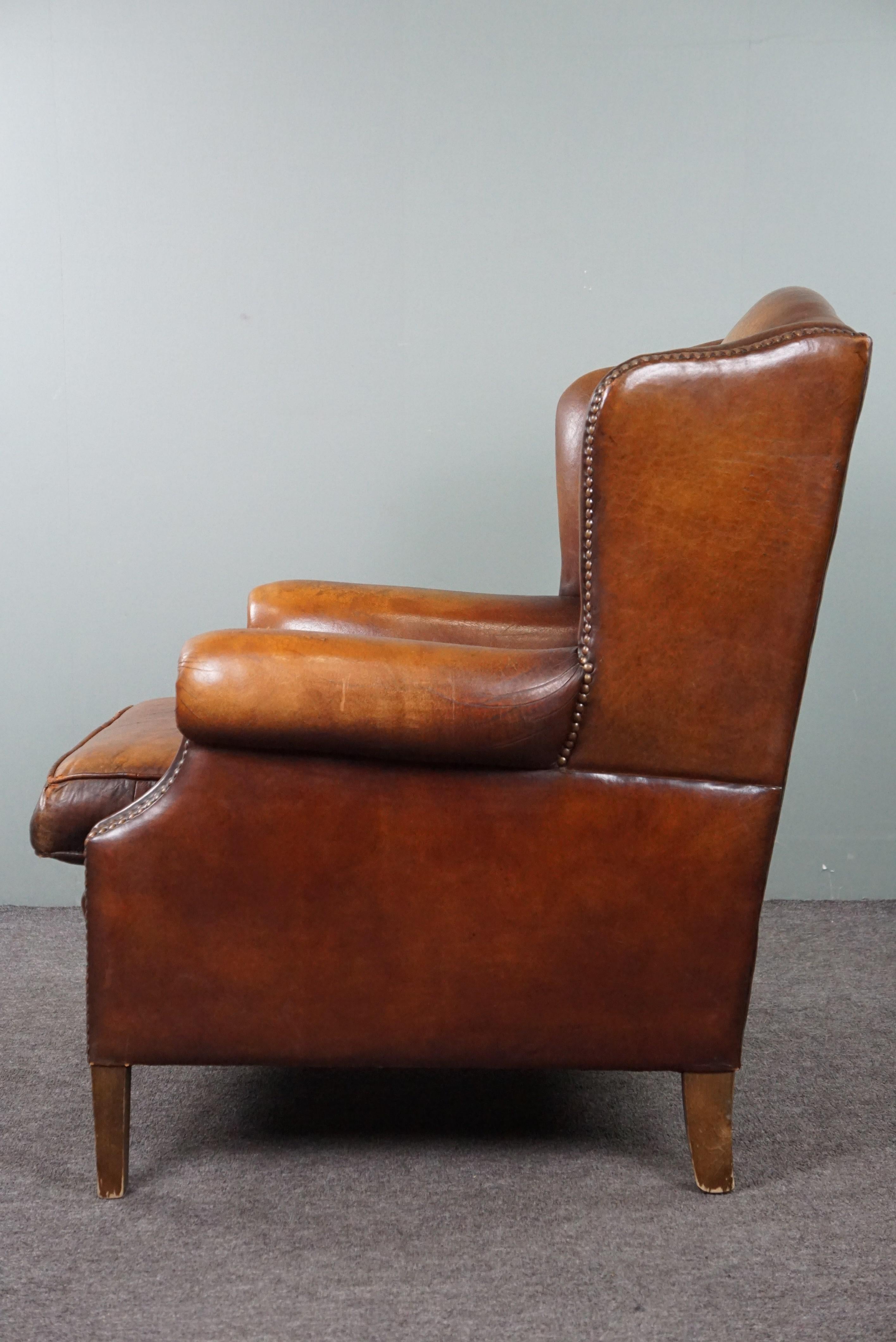 Leather Sheep leather wingback chair with a beautiful patina For Sale