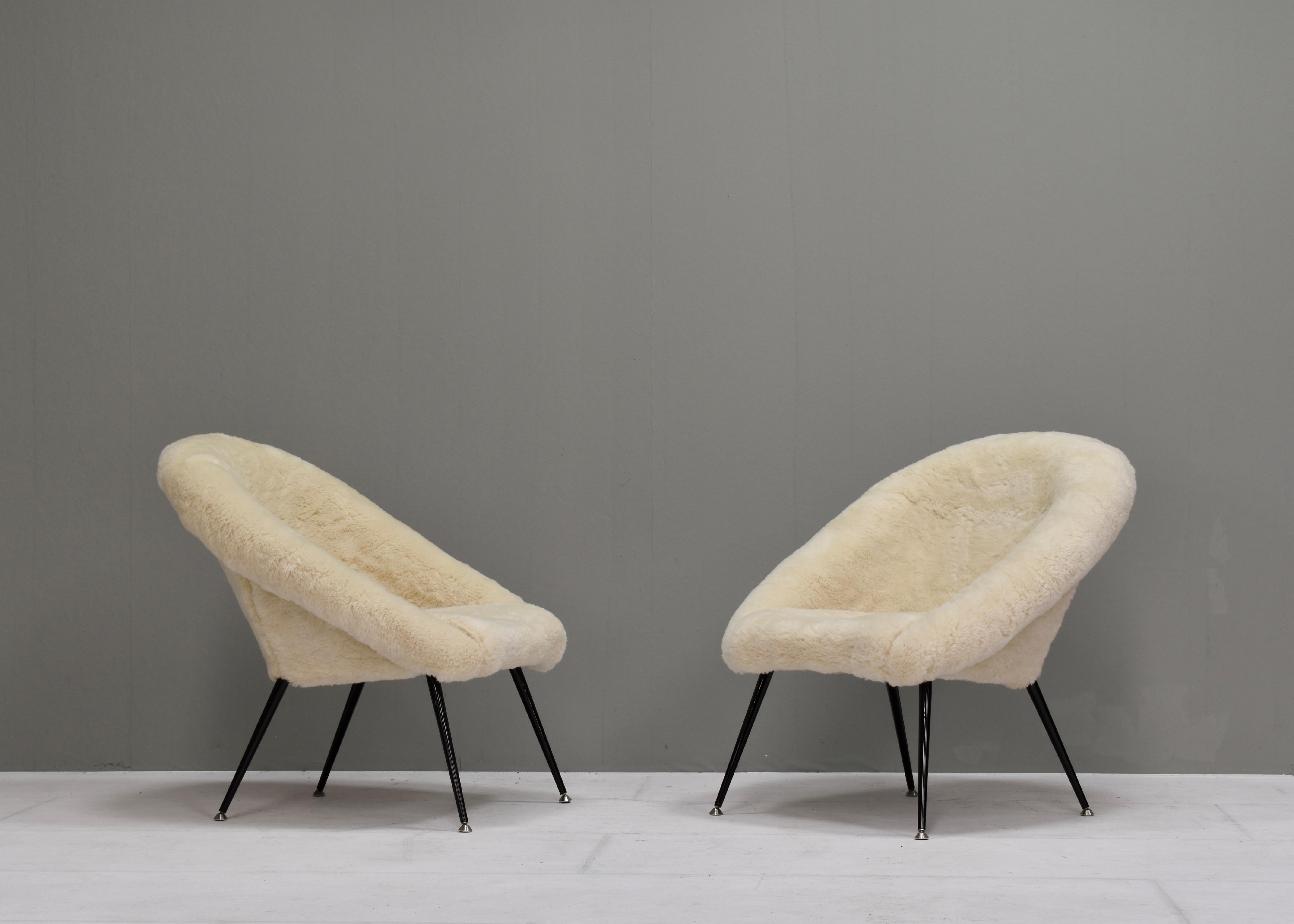 Elegant armchair new upholstered in thick real Sheep wool.
1 Chair available.
The chair is labeled August 3d 1970.
The legs are made of black lacquered steel with chrome feet. 

Designer: in the manor of Fritz Neth
Manufacturer: