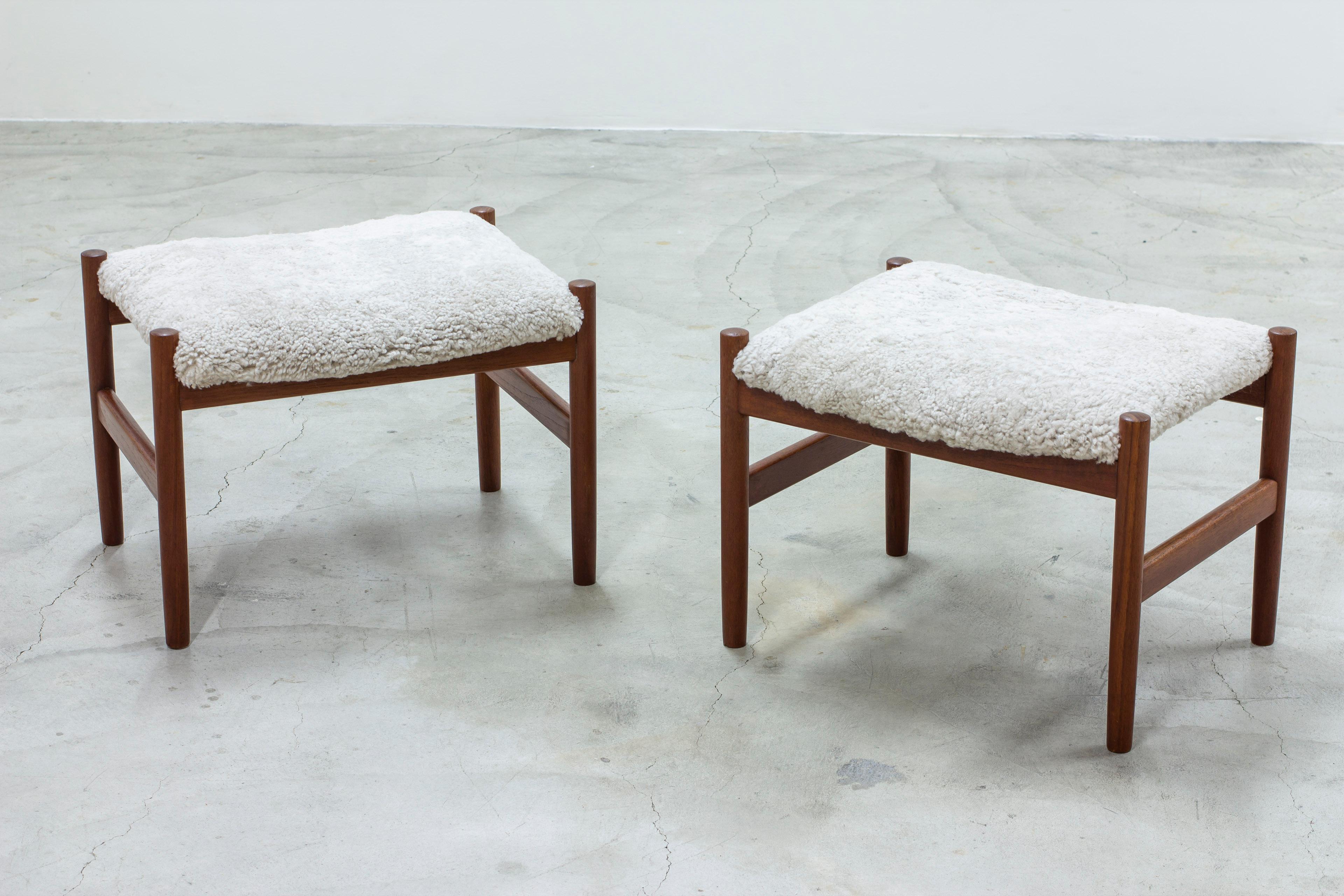 Pair of stools designed by Hugo Frandsen. Produced by Spøttrup in Denmark during the 1960s. Made from solid teak with new sheep skin upholstery. Very good vintage condition with light signs of age related wear and patina.

Price for the pair.