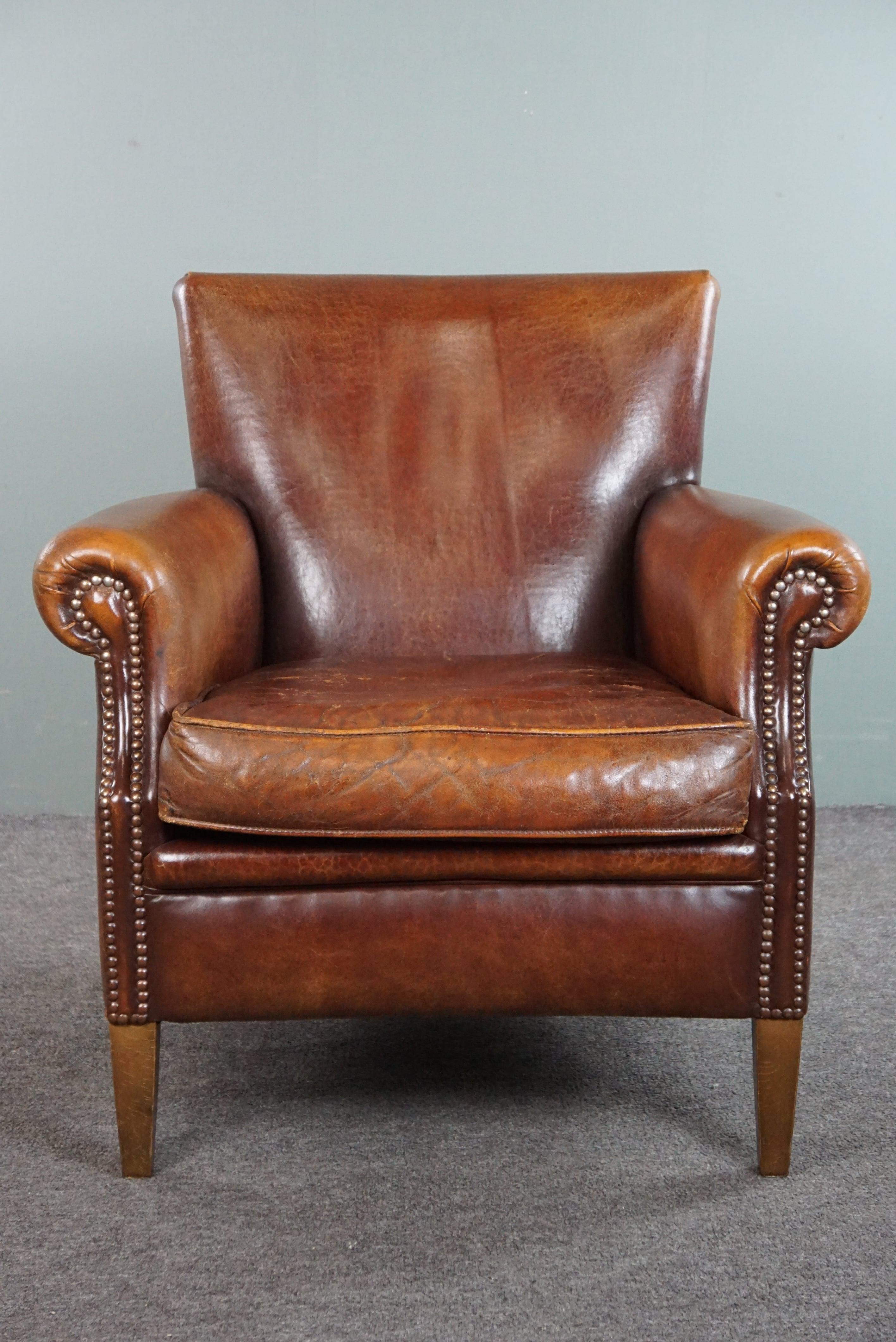 Offered is this sheepskin armchair with a wonderful patina and a correct worn look. 

We proudly offer this sheepskin armchair for sale because we believe it is a beautiful example of how a vintage sheepskin armchair should be. It also has a nice
