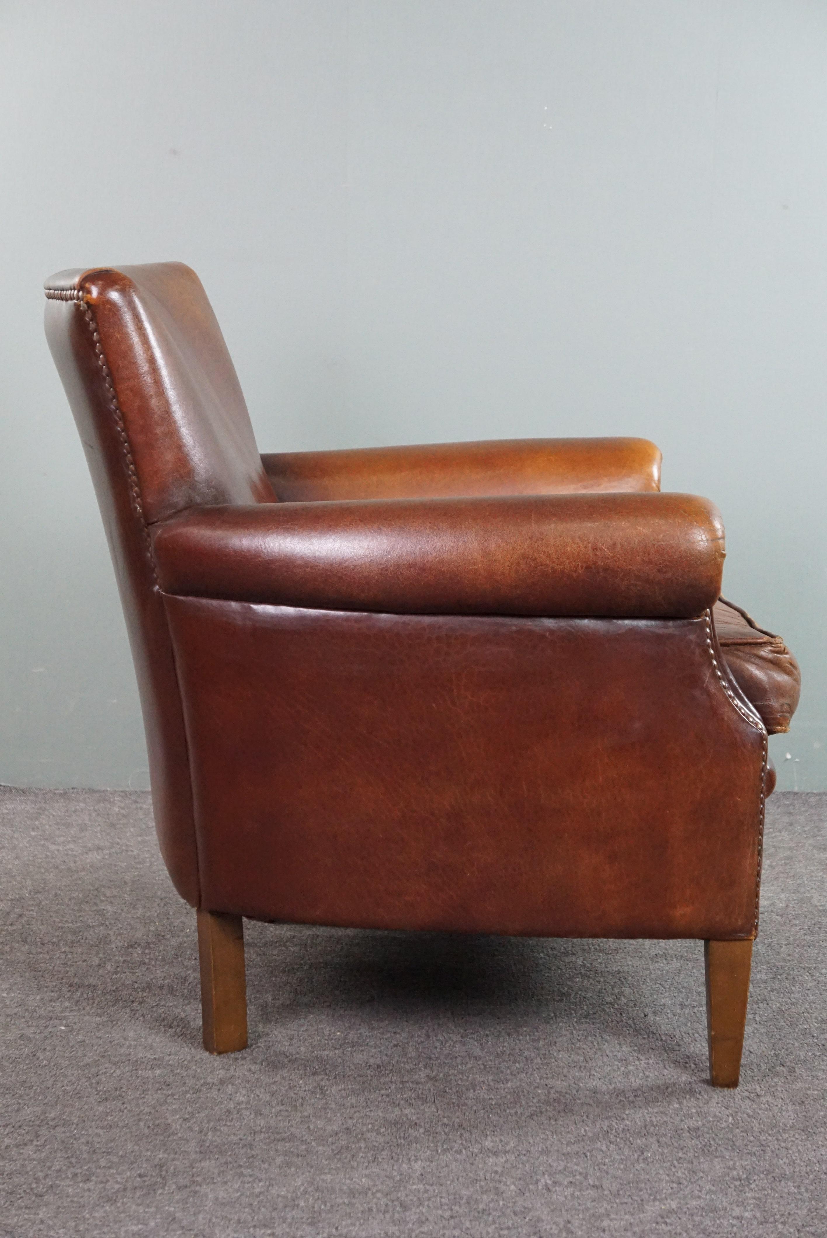 Country Sheepskin armchair with a wonderful patina and a correct worn look For Sale