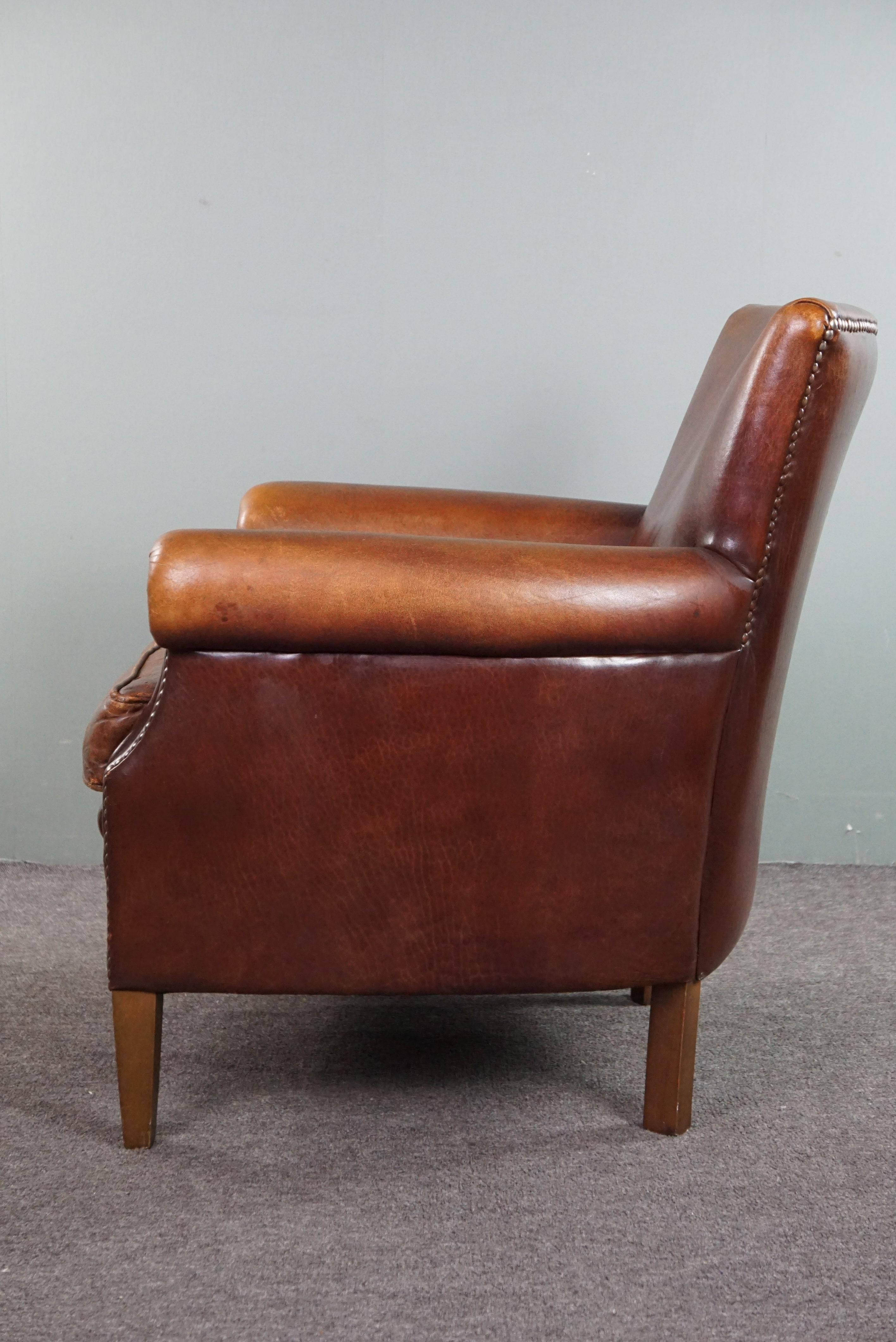 Late 20th Century Sheepskin armchair with a wonderful patina and a correct worn look For Sale