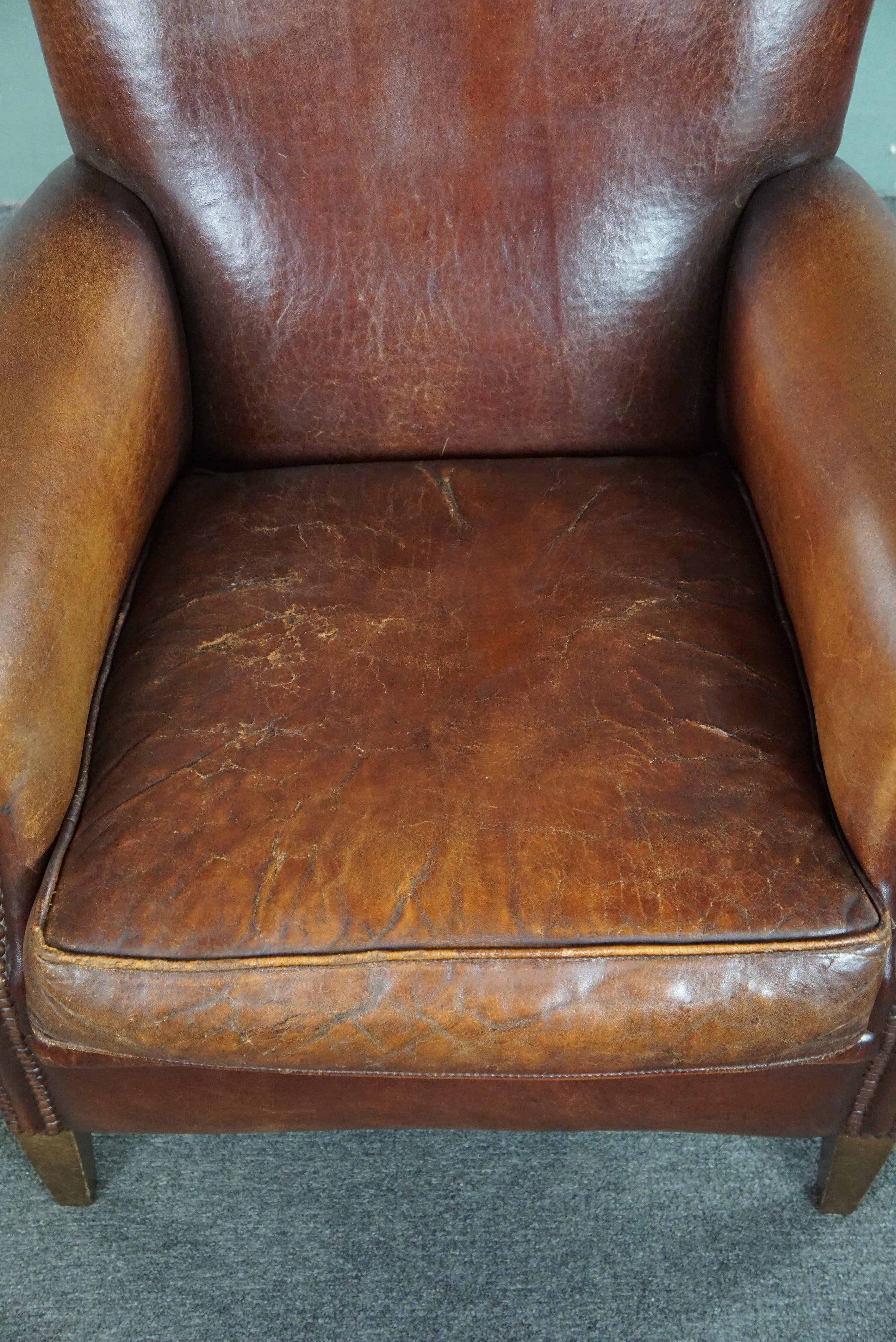 Leather Sheepskin armchair with a wonderful patina and a correct worn look For Sale
