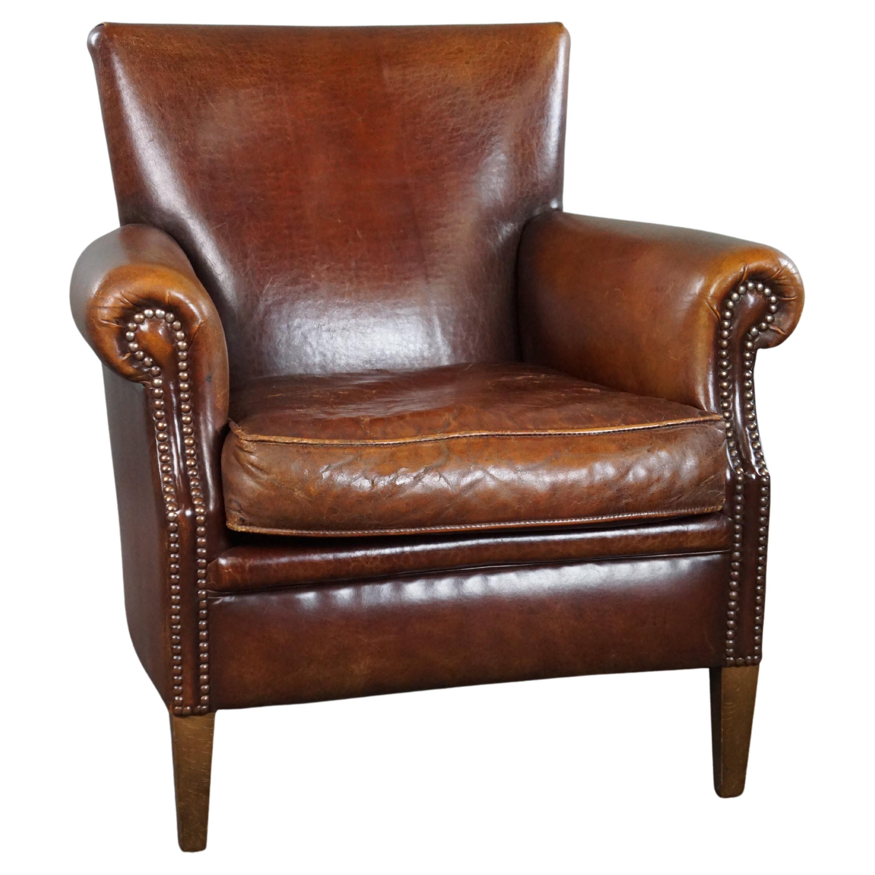 Sheepskin armchair with a wonderful patina and a correct worn look For Sale