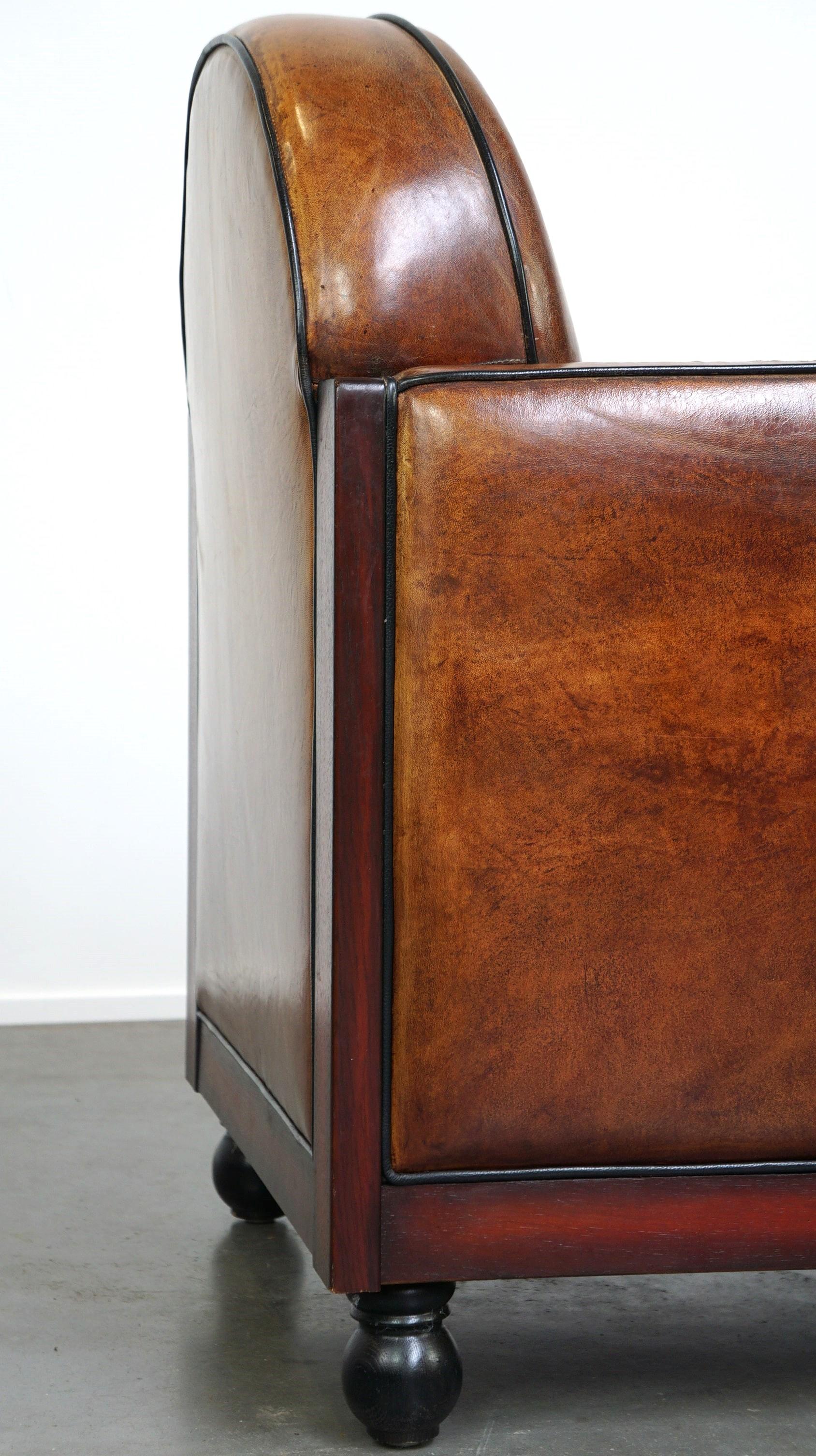Sheepskin Art Deco design armchair finished with wood and cognac-colored leather For Sale 6