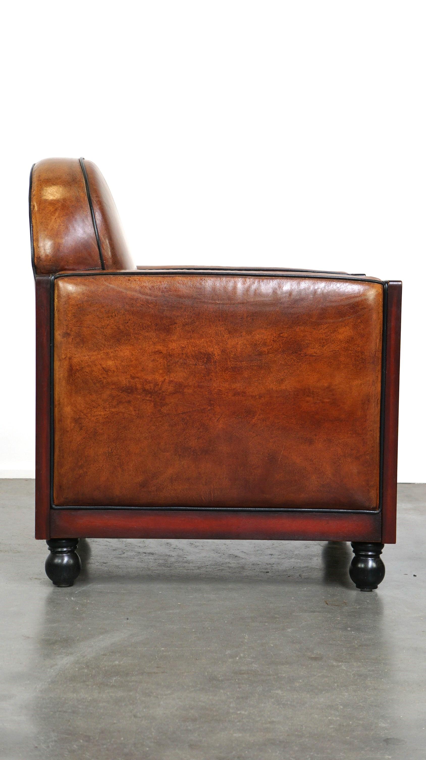 Dutch Sheepskin Art Deco design armchair finished with wood and cognac-colored leather For Sale