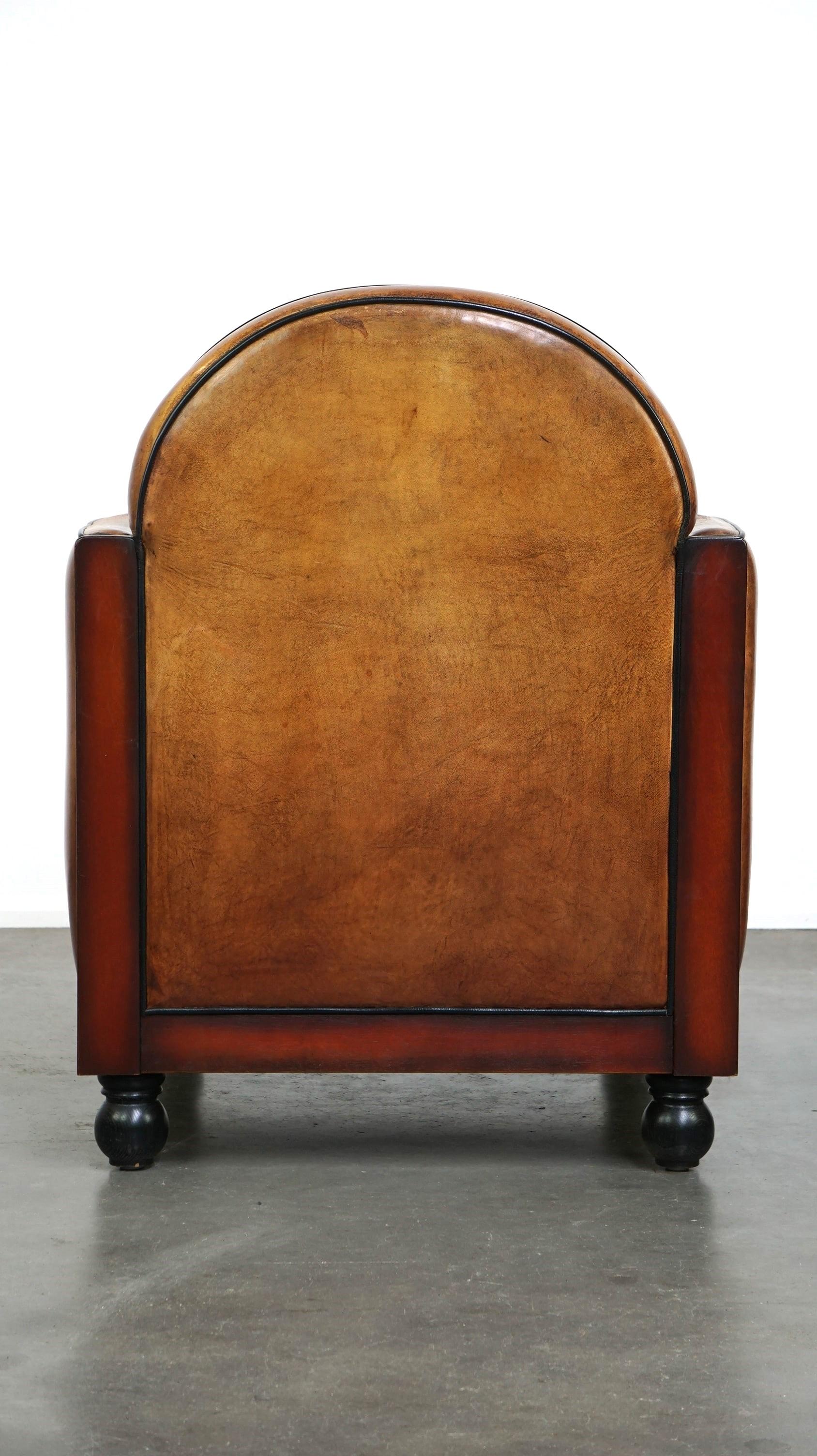 Hand-Crafted Sheepskin Art Deco design armchair finished with wood and cognac-colored leather For Sale