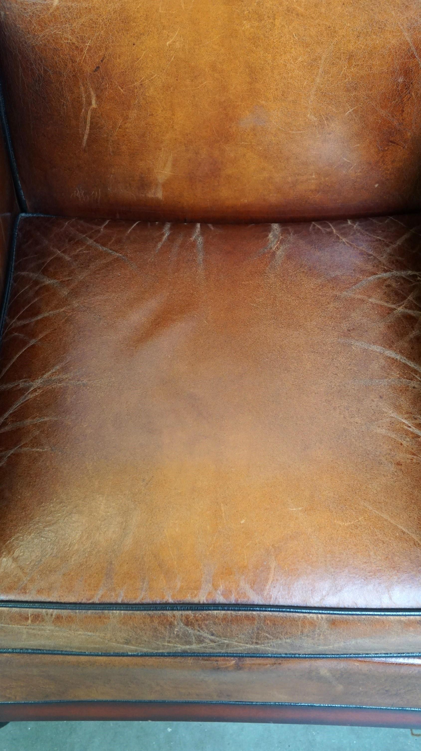 Contemporary Sheepskin Art Deco design armchair finished with wood and cognac-colored leather For Sale