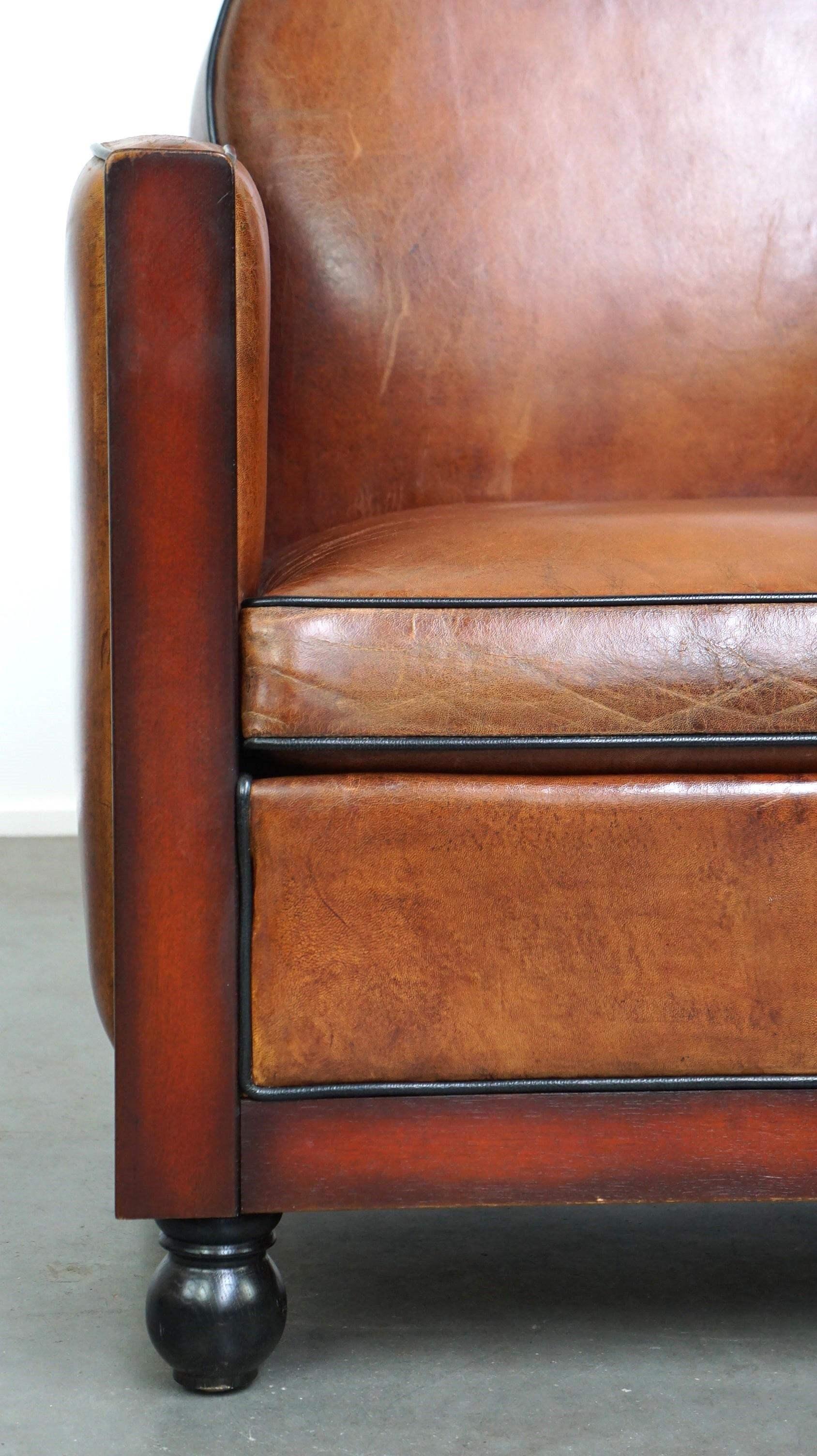 Leather Sheepskin Art Deco design armchair finished with wood and cognac-colored leather For Sale