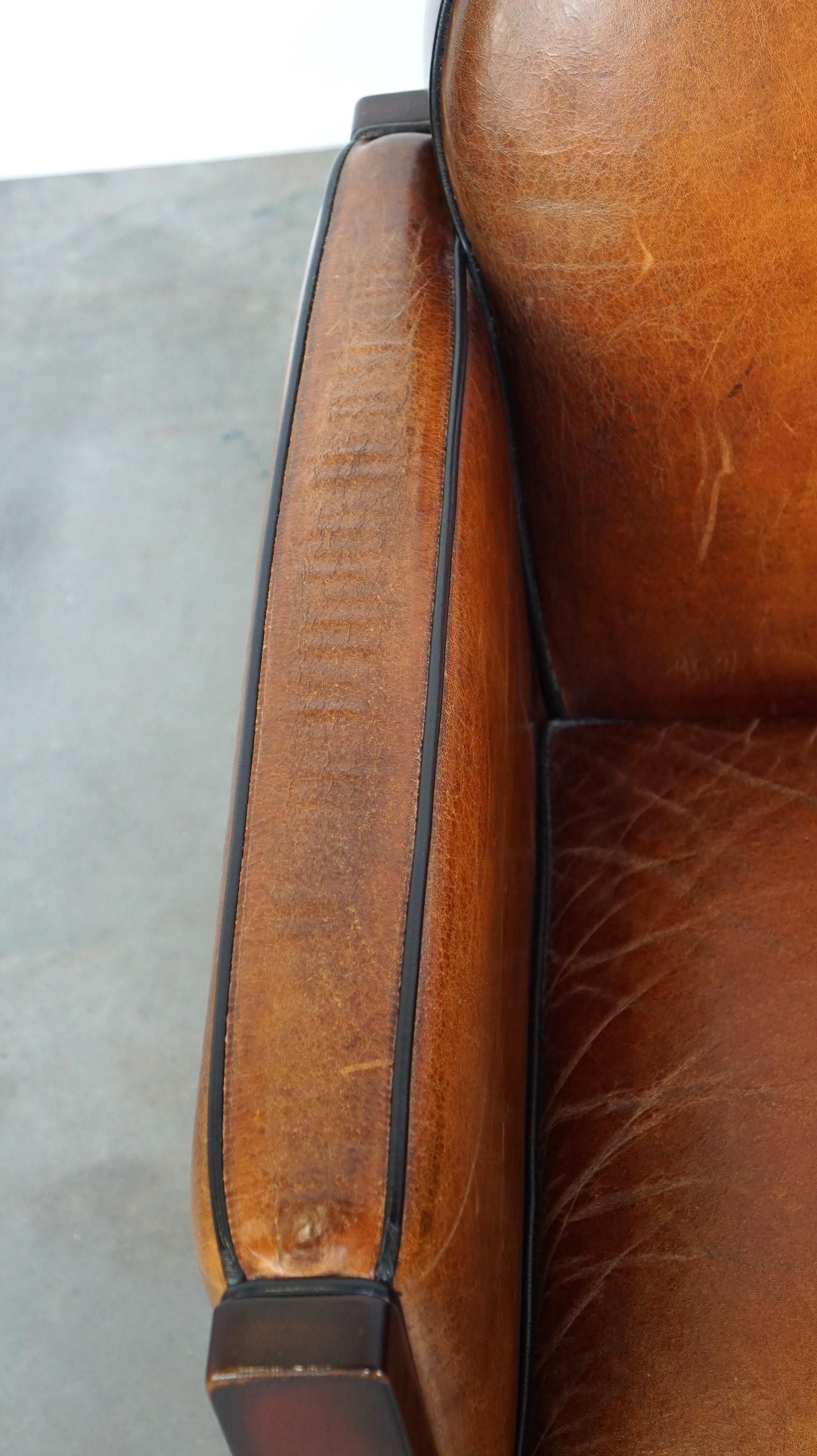 Sheepskin Art Deco design armchair finished with wood and cognac-colored leather For Sale 1