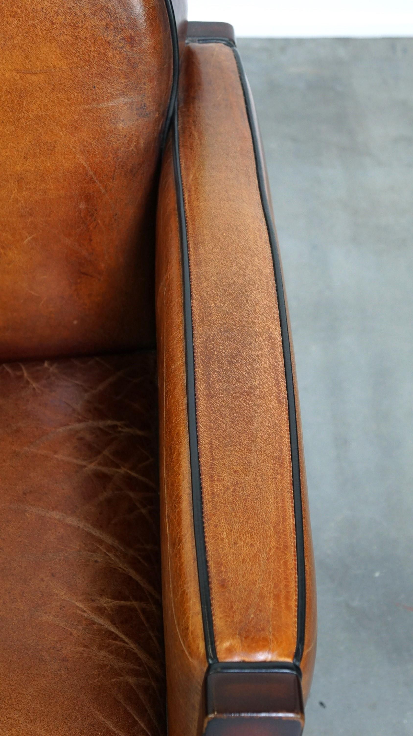 Sheepskin Art Deco design armchair finished with wood and cognac-colored leather For Sale 2