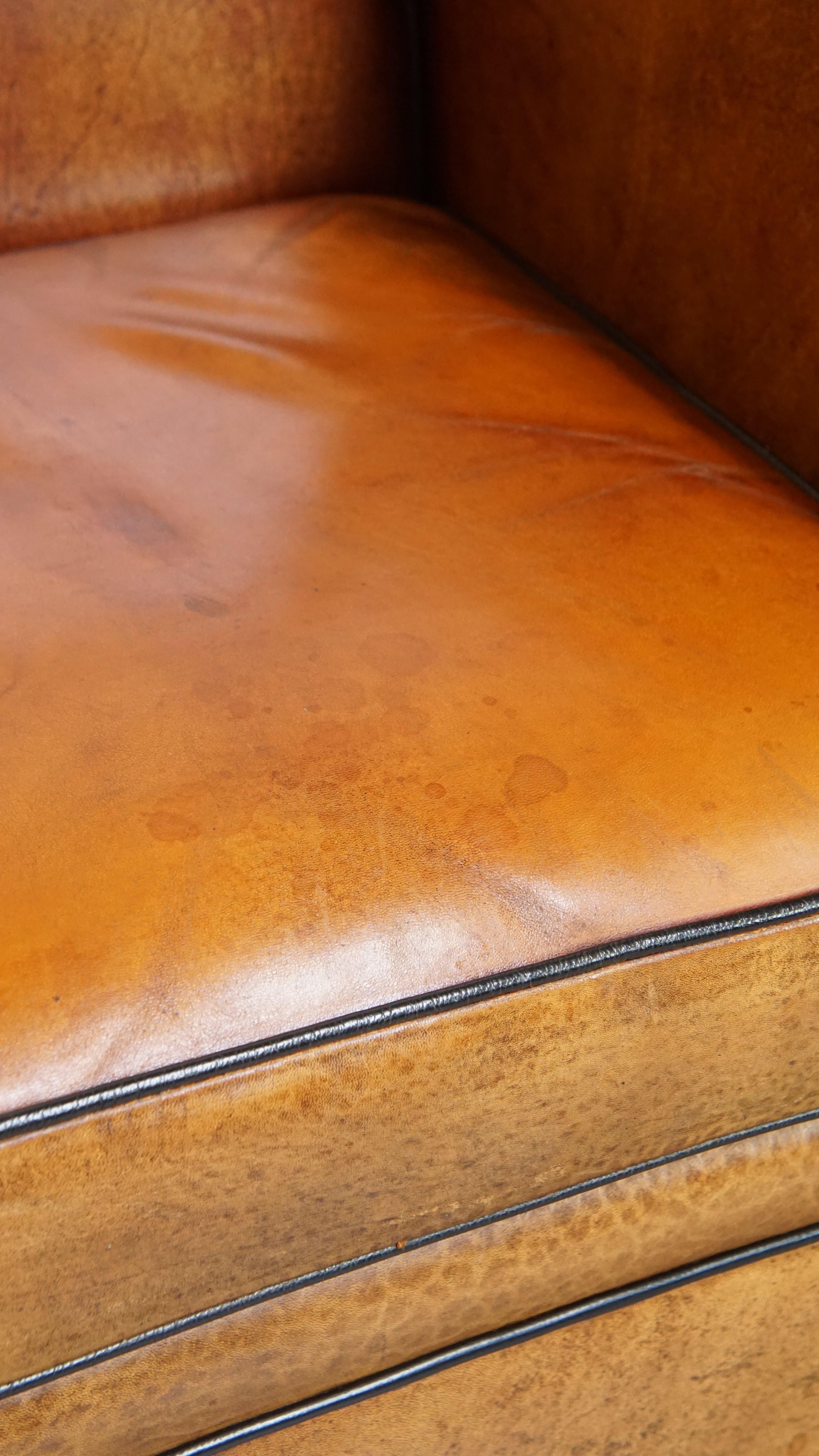 Sheepskin Art Deco design armchair with gorgeous wooden details and black piping For Sale 5