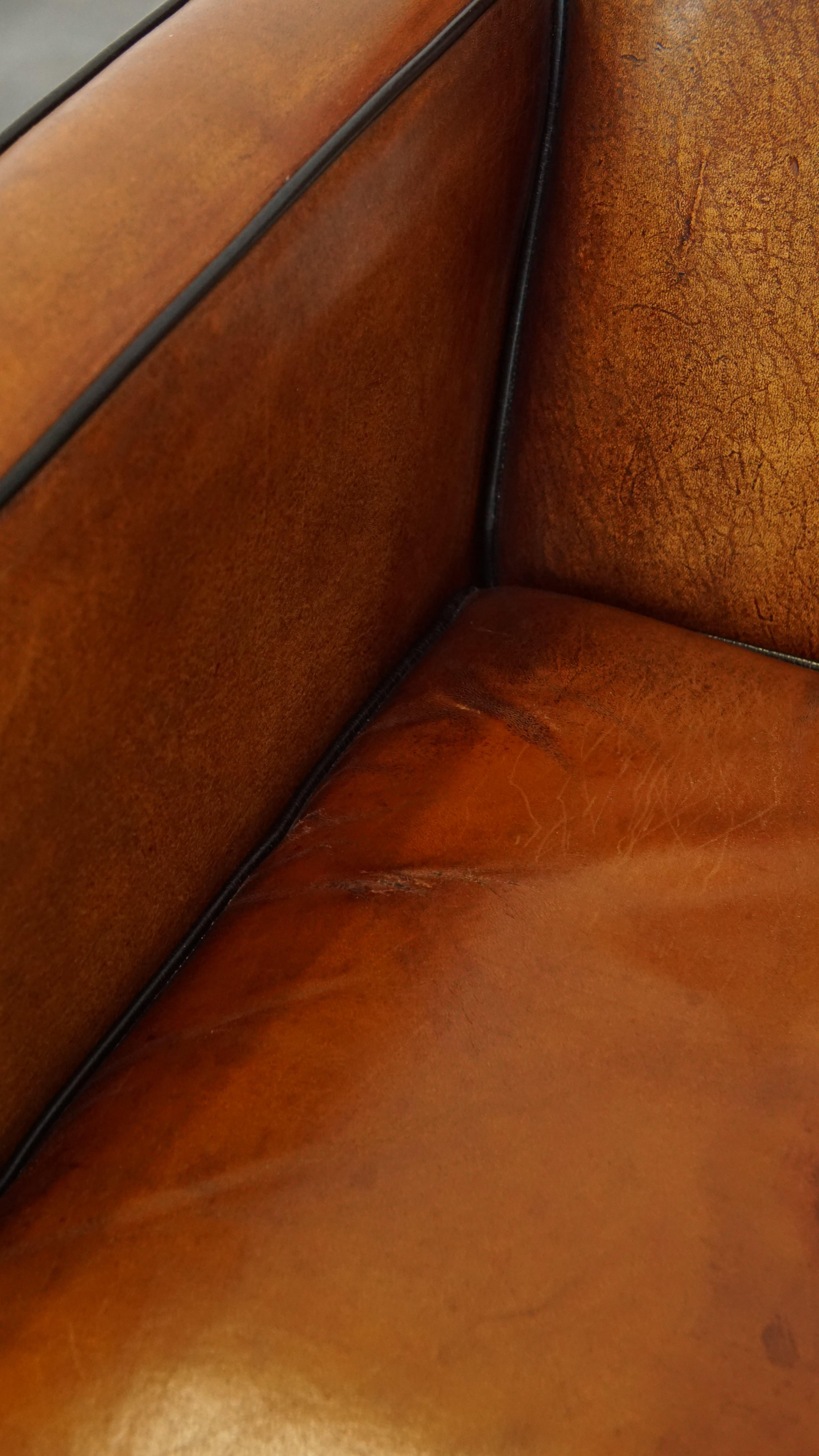 Sheepskin Art Deco design armchair with gorgeous wooden details and black piping For Sale 6