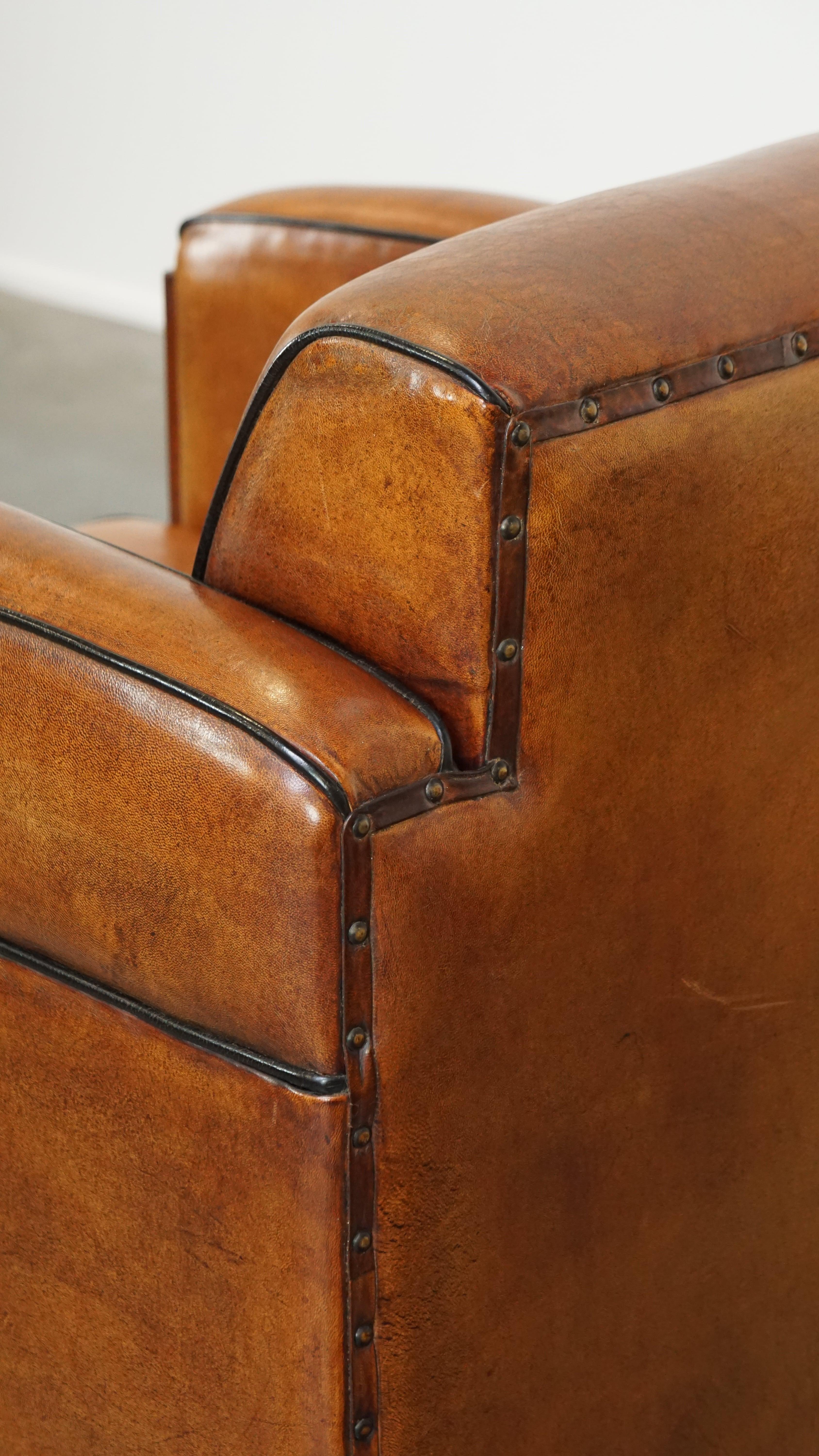 Sheepskin Art Deco design armchair with gorgeous wooden details and black piping For Sale 7